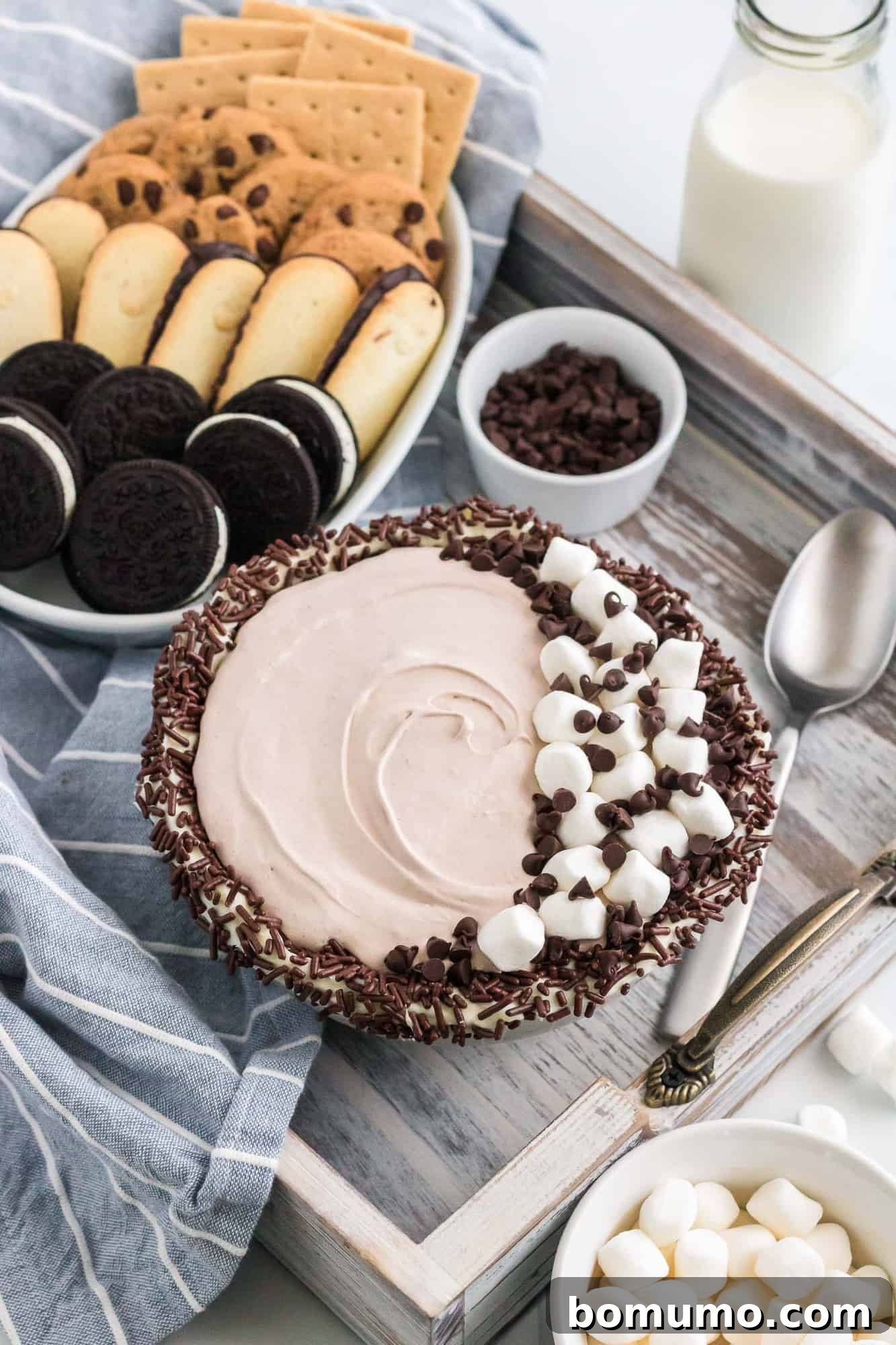The finished hot chocolate dip beautifully presented on a tray, surrounded by a delightful variety of dippers.