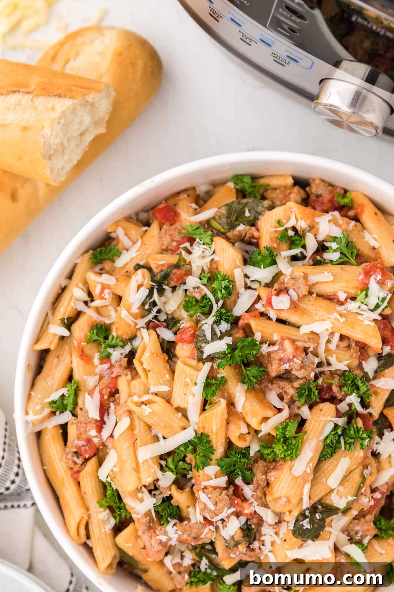 An inviting overhead view of a serving of Instant Pot pasta in a white bowl, garnished and ready to eat.