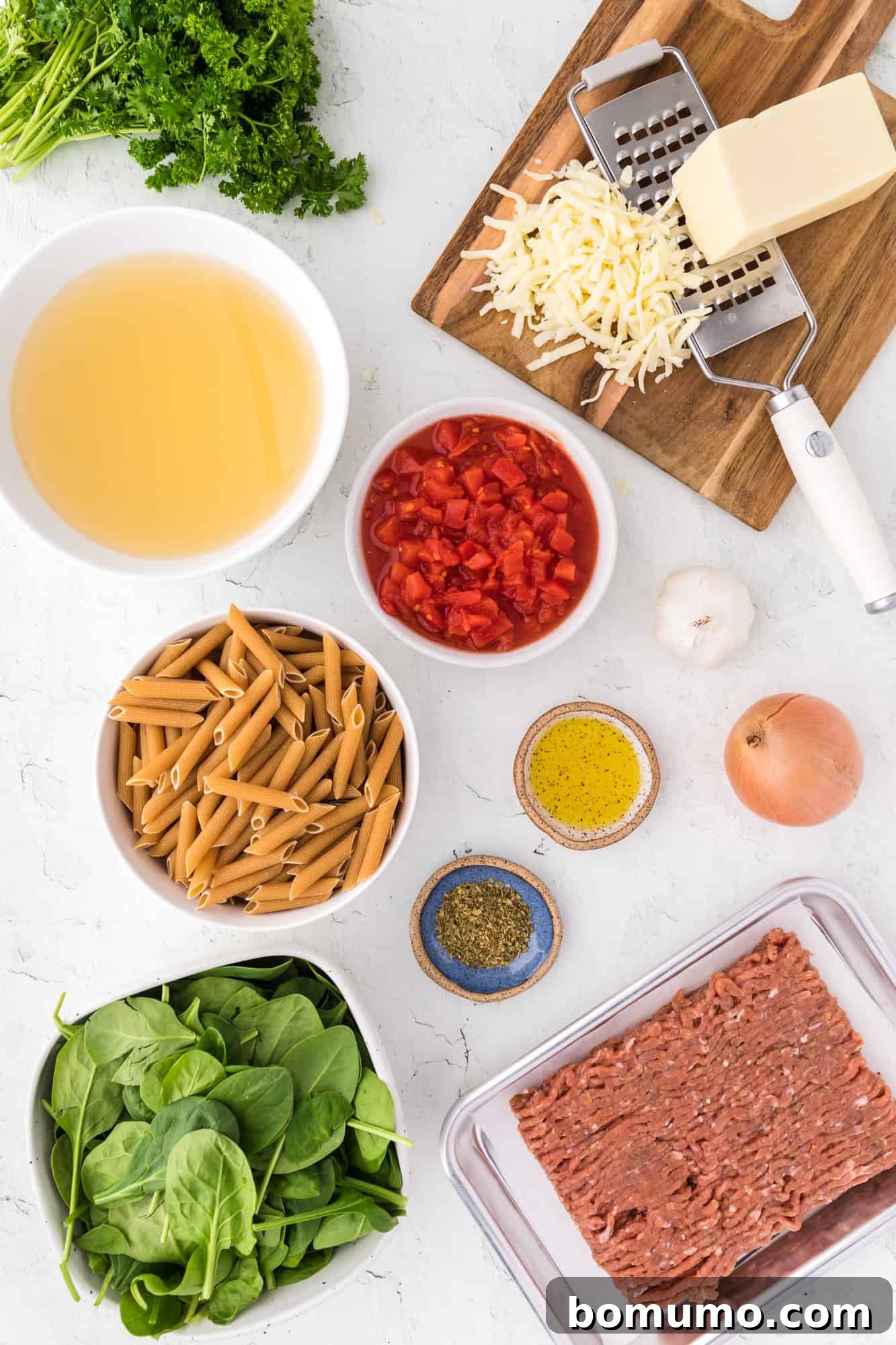 All essential ingredients for the Instant Pot pasta recipe neatly arranged, including pasta, sausage, vegetables, and seasonings.