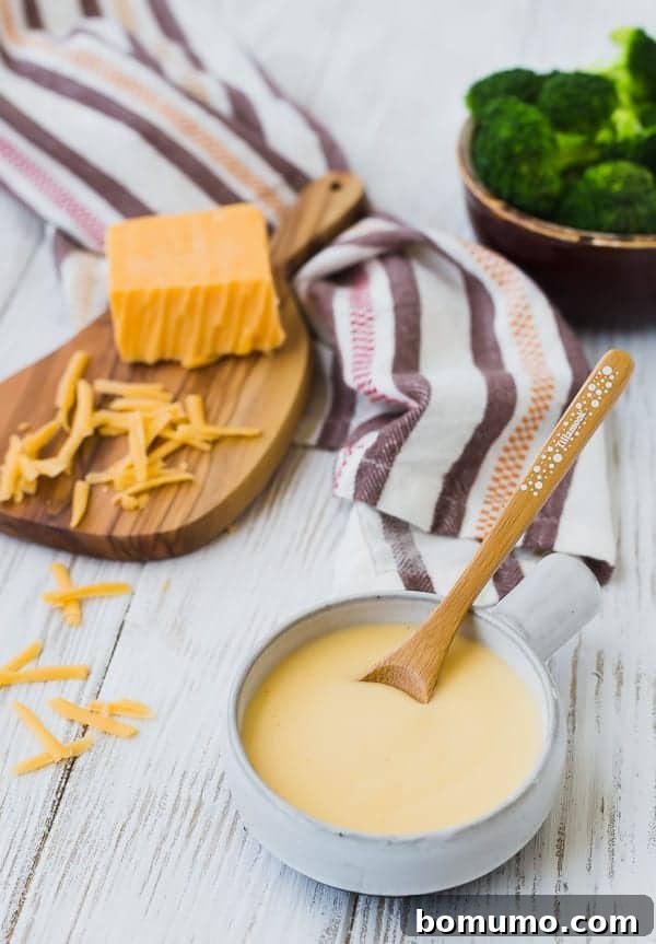 Creamy easy cheese sauce with cheddar, ready to be poured over your favorite dishes.