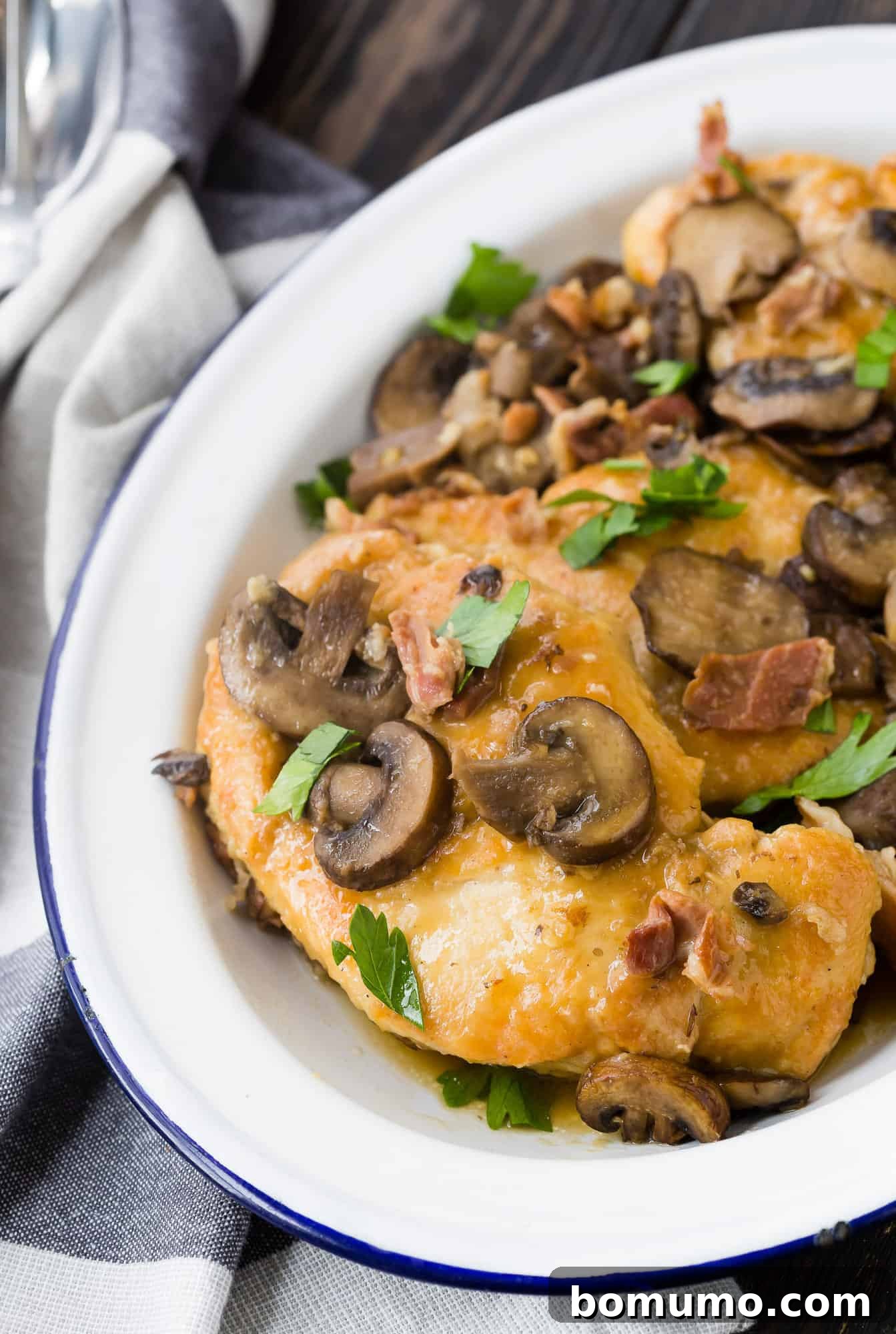 A perfectly cooked Instant Pot Chicken Marsala, featuring tender chicken breasts coated in a rich, mushroom-studded Marsala wine sauce, served on a pristine white platter.