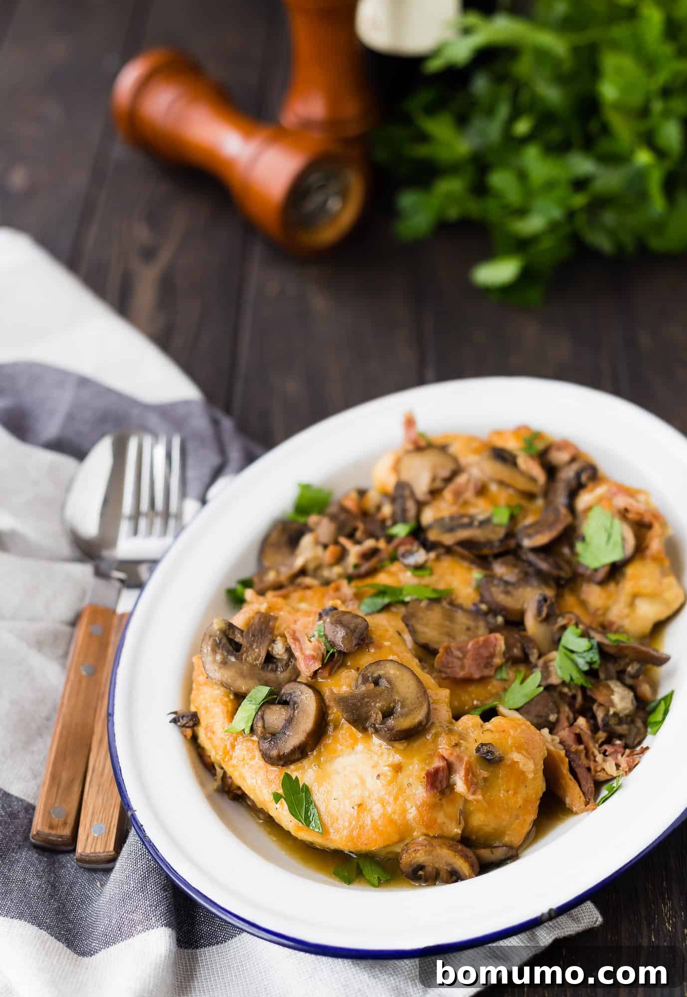 A serving of succulent Instant Pot Chicken Marsala garnished with fresh parsley on a white plate, highlighting the rich sauce and tender mushrooms.
