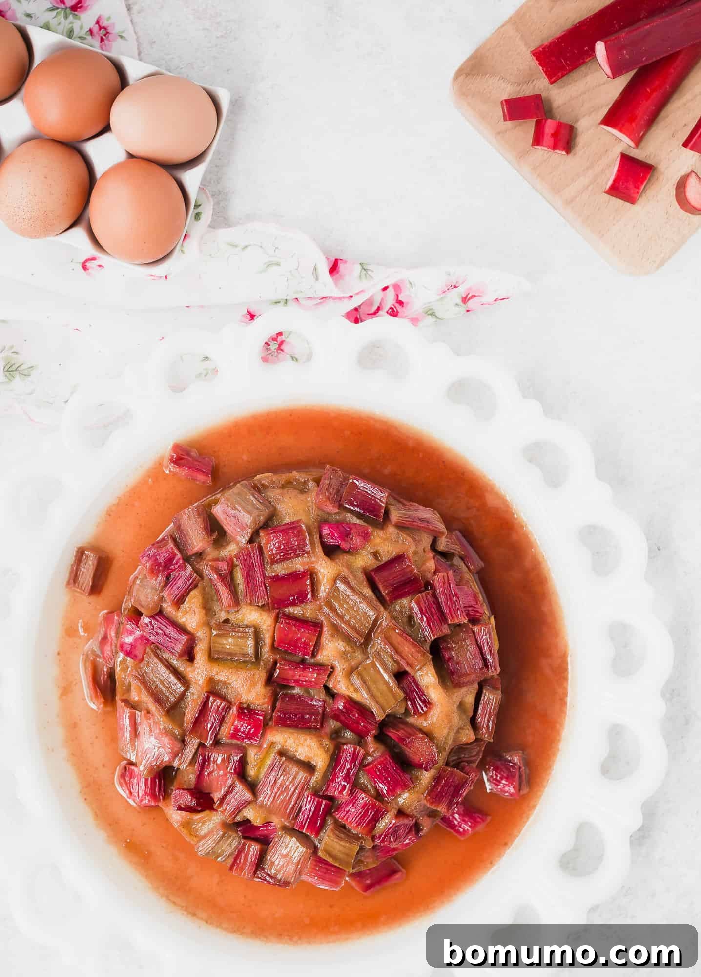 An inviting overhead shot of a Rhubarb Instant Pot Cake, studded with vibrant rhubarb pieces, showcasing its beautiful texture and homemade appeal.