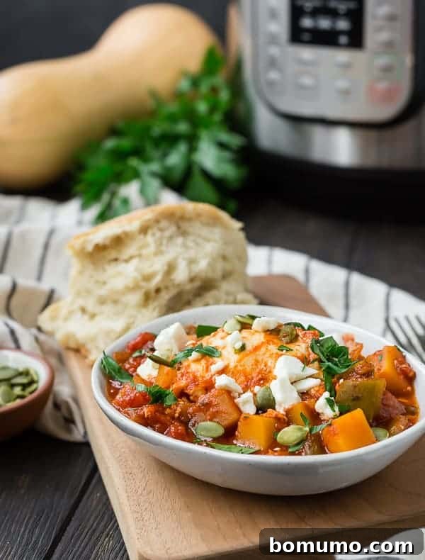 Small bowl of tomatoes, eggs, feta cheese, and pepitas. An instant pot is pictured in the background.