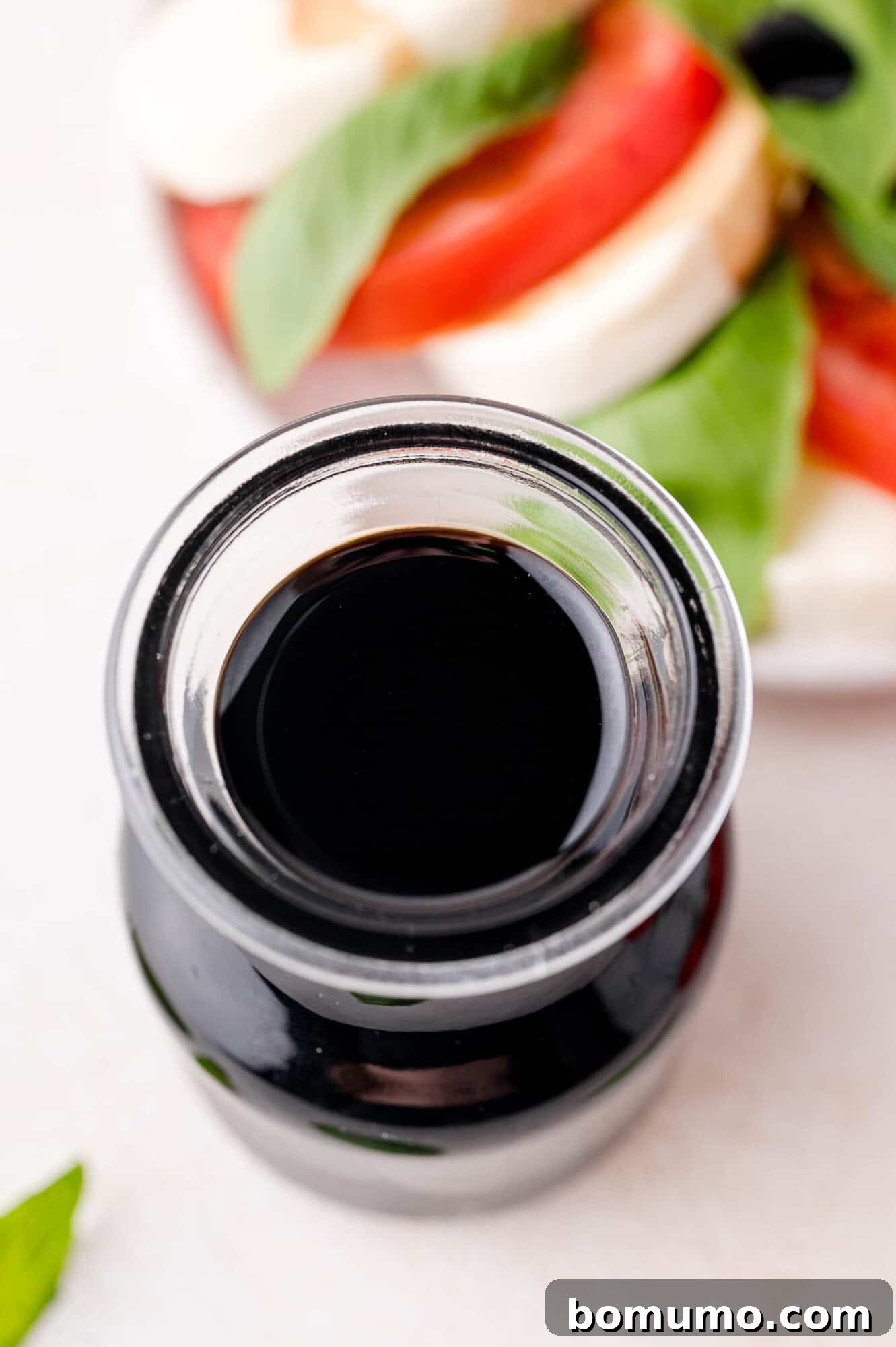 Freshly made balsamic glaze stored in a small, elegant glass jar, ready for future use.