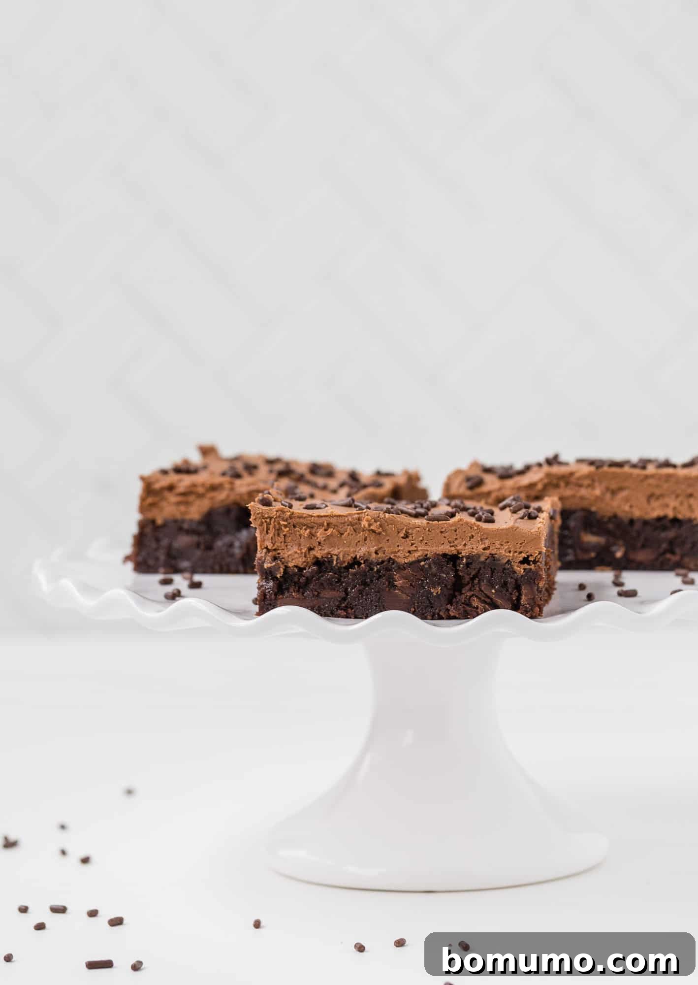 Effortless Mocha Brownies 2 Mocha brownies with frosting and sprinkles.