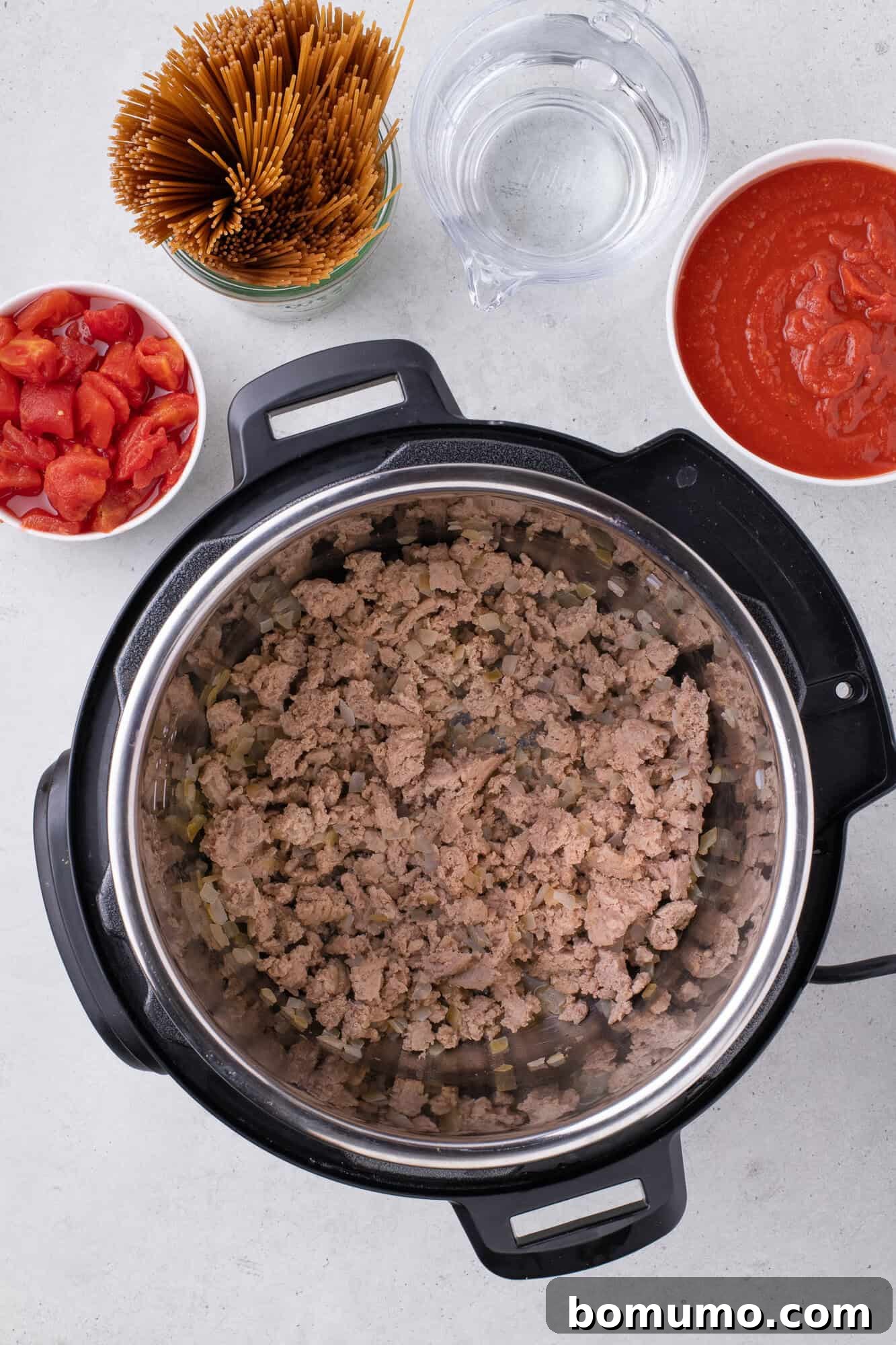 Perfectly sautéed ground turkey and tender onions in an Instant Pot, golden brown and fragrant, creating a delicious foundation for the one-pot spaghetti.