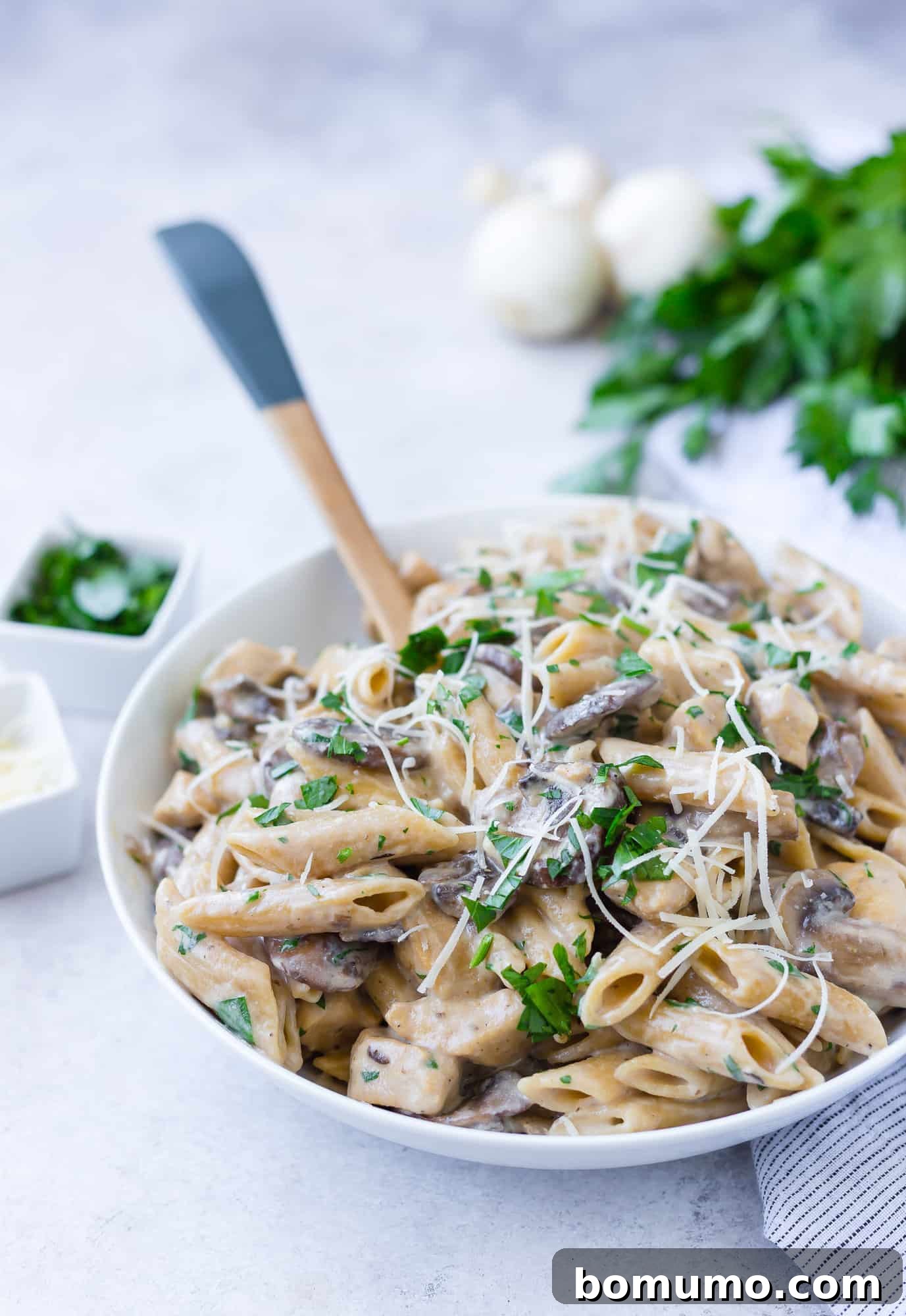One pan chicken marsala pasta garnished with cheese.