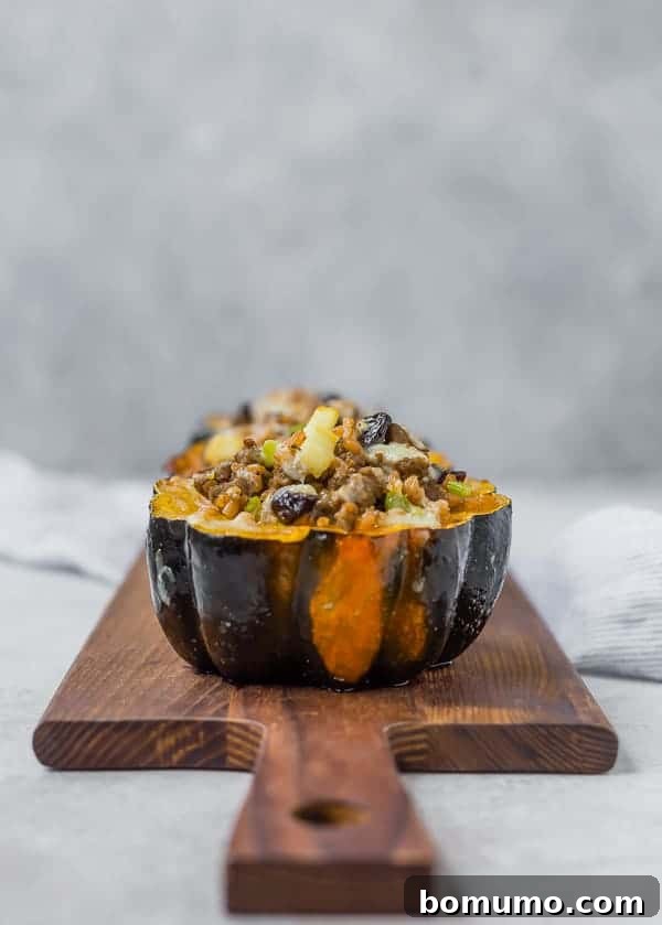 Beautifully roasted and stuffed acorn squash halves arranged neatly on a wooden serving platter, showcasing their golden-brown edges and rich filling.