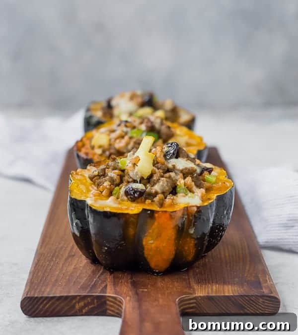 A collection of beautifully cooked stuffed acorn squash halves arranged on a wooden serving platter, ready for a cozy autumn meal.