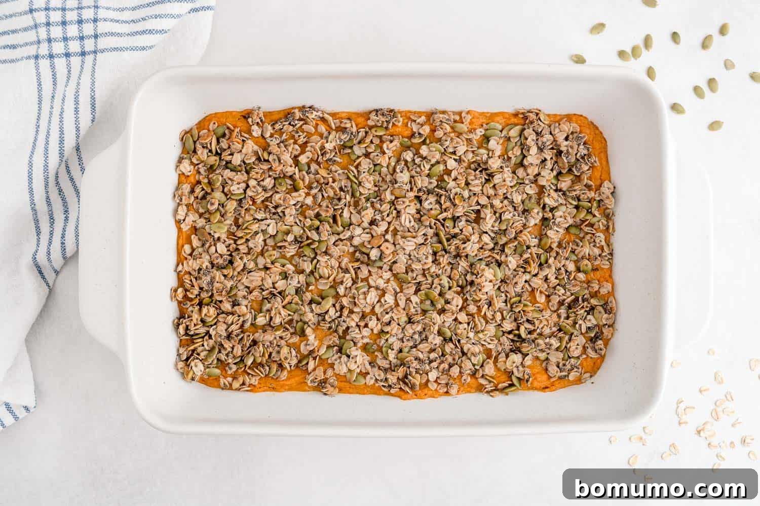 A freshly baked healthy sweet potato casserole, showcasing its perfectly golden and crunchy oat topping.