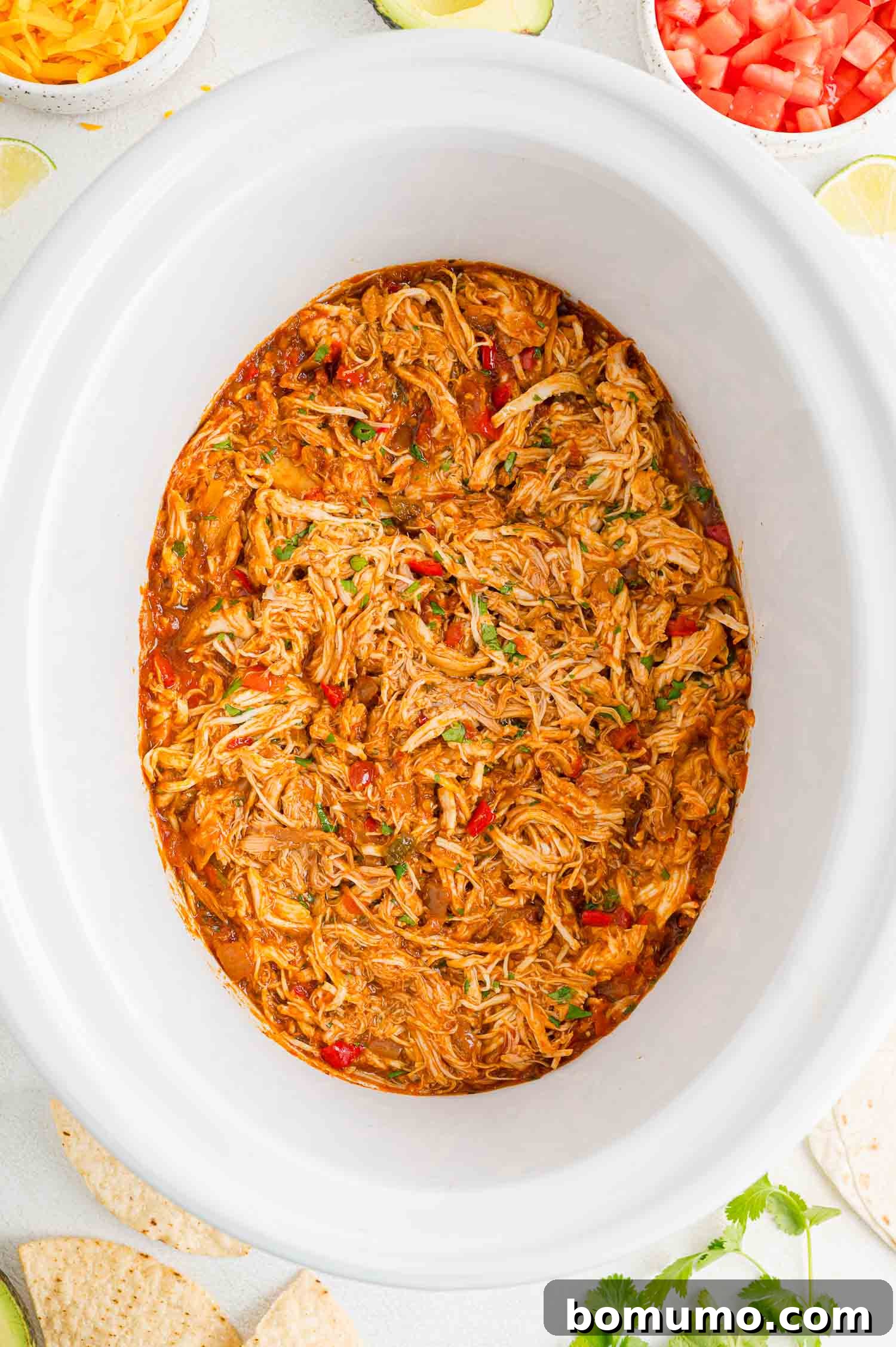 Finished shredded salsa chicken inside the crockpot.