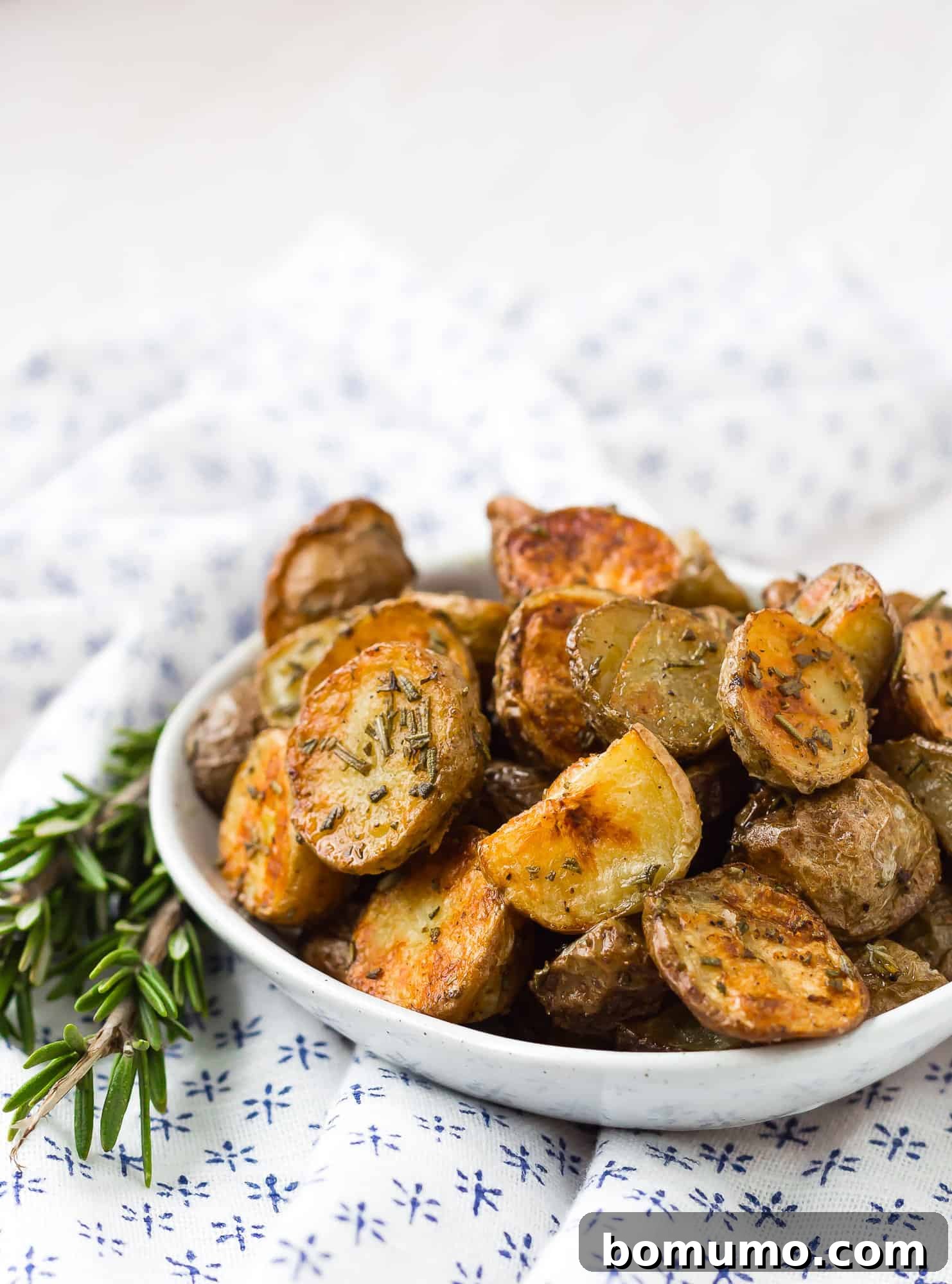 Golden brown potatoes in a small bowl.