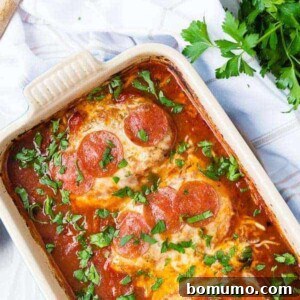 image of chicken topped with cheese and pepperoni in a baking dish