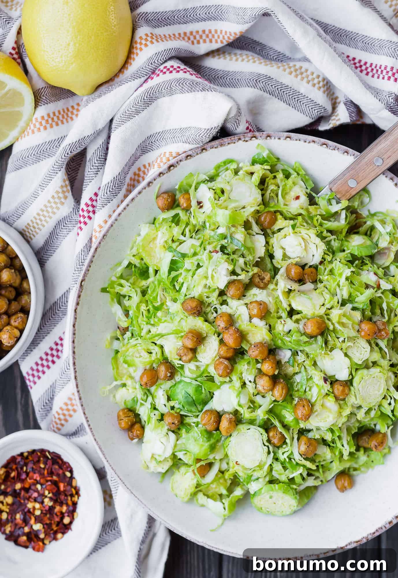 Overhead view of a refreshing Brussels sprouts salad generously topped with crispy chickpeas.
