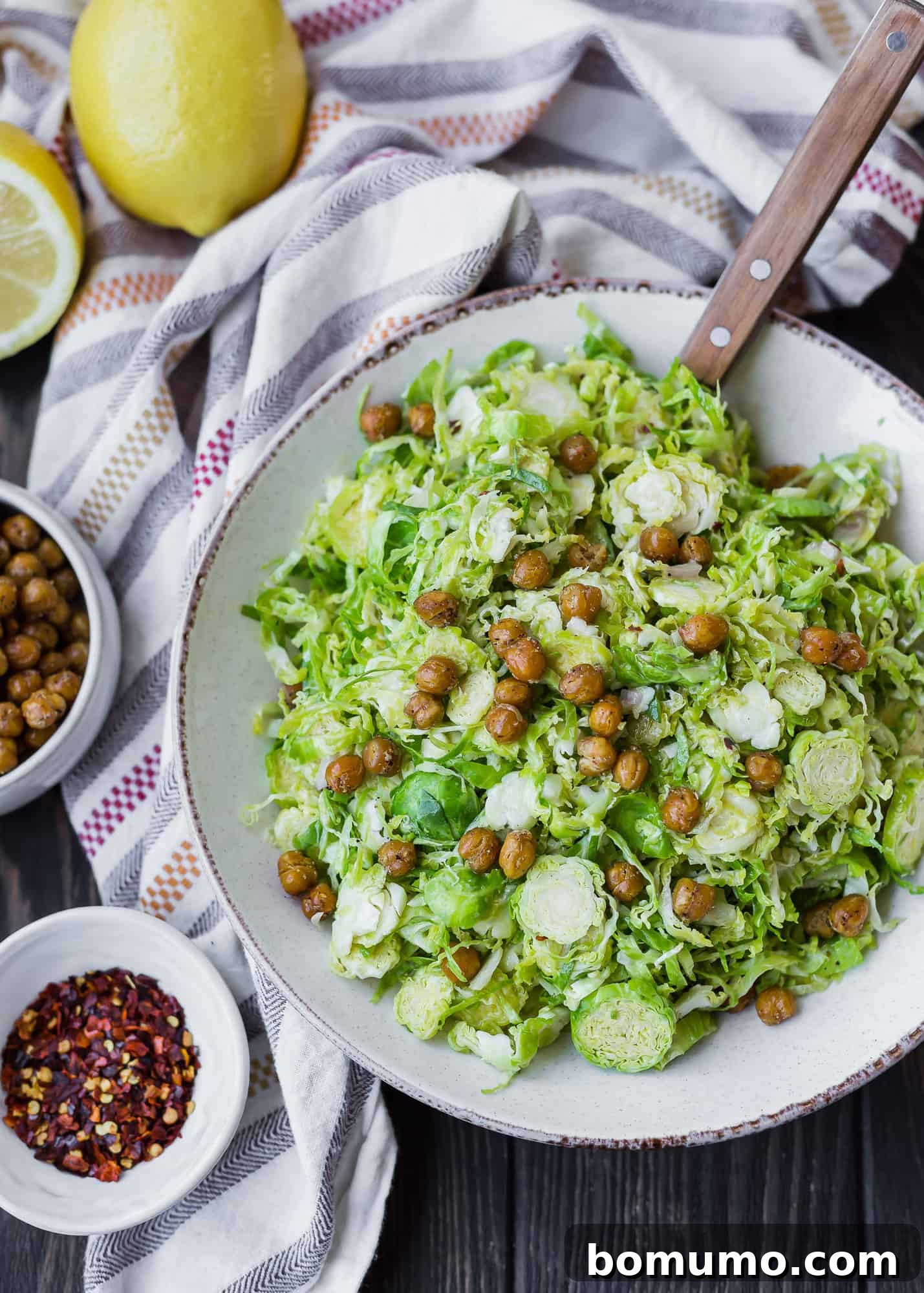 A close-up of shaved Brussels sprouts mingling with crispy chickpeas, ready to be dressed.