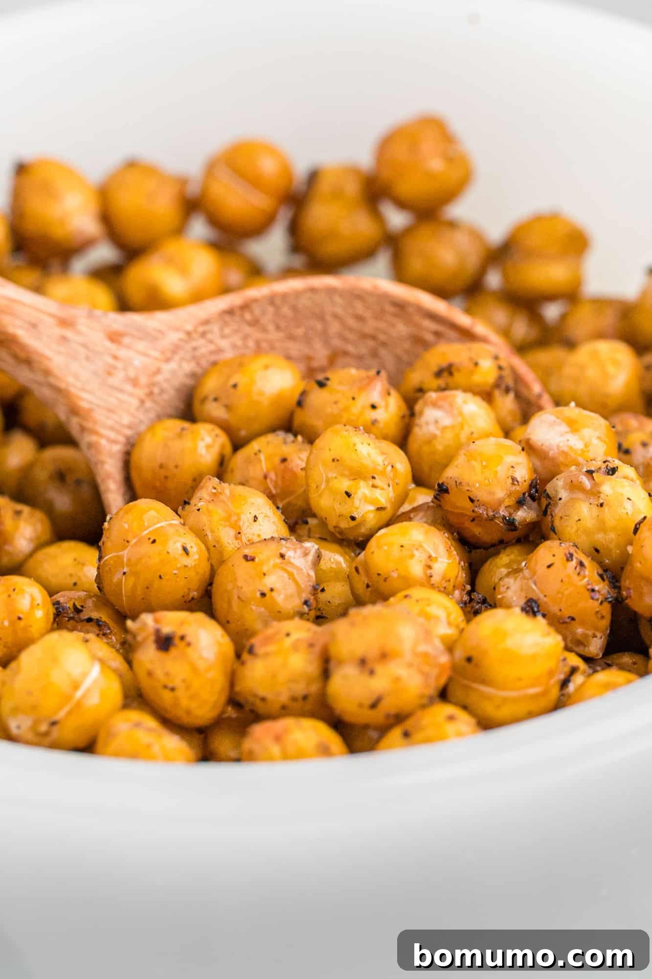 Close up view of crispy chickpeas in a white glass bowl. Perfect for healthy snacking.