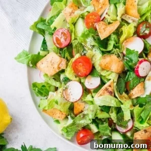 Square image of Fattoush salad topped with golden crispy pita pieces, highlighting the key textural element.
