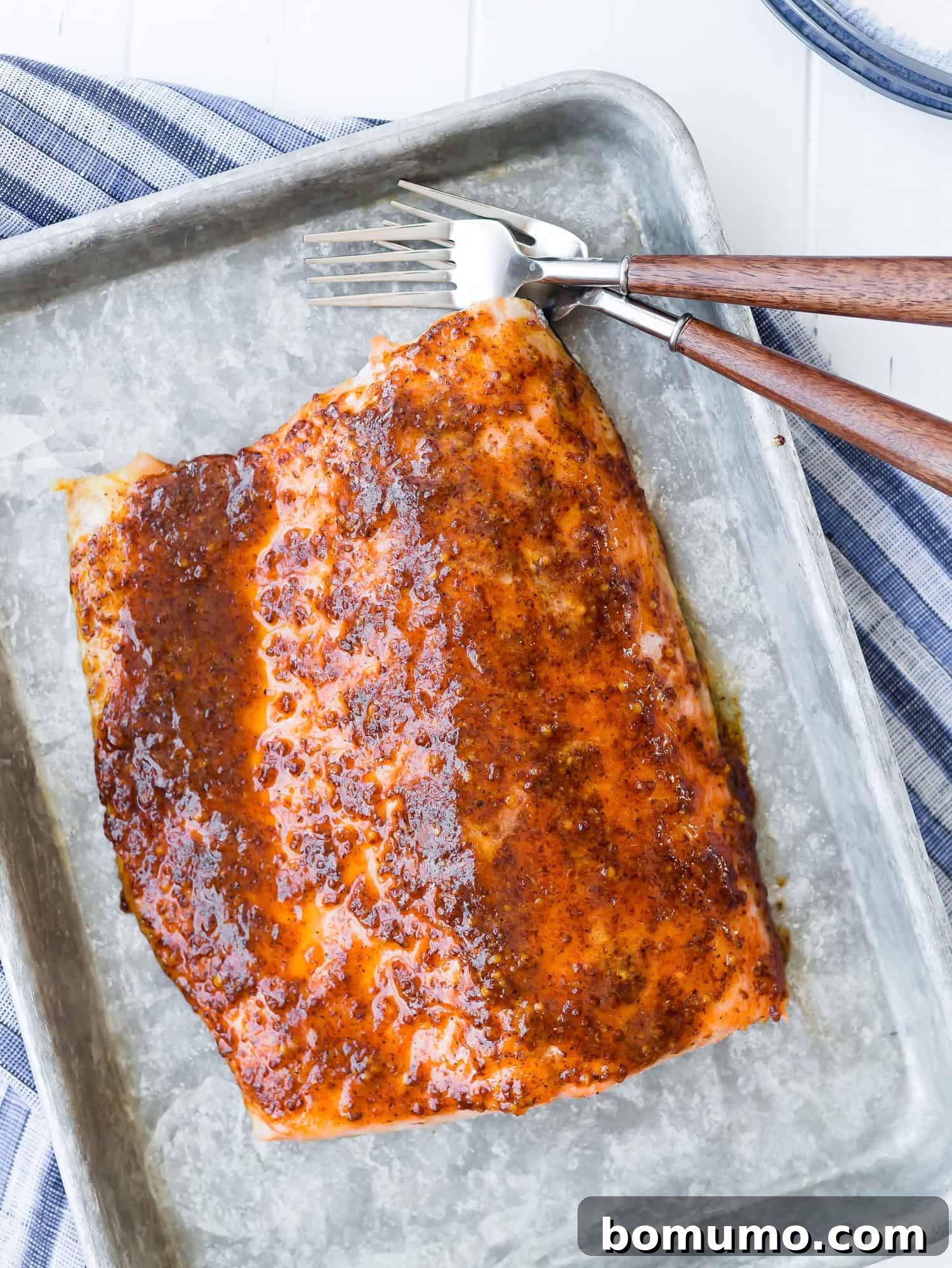 Overhead view of maple mustard baked salmon on a sheet pan, ready to be served.