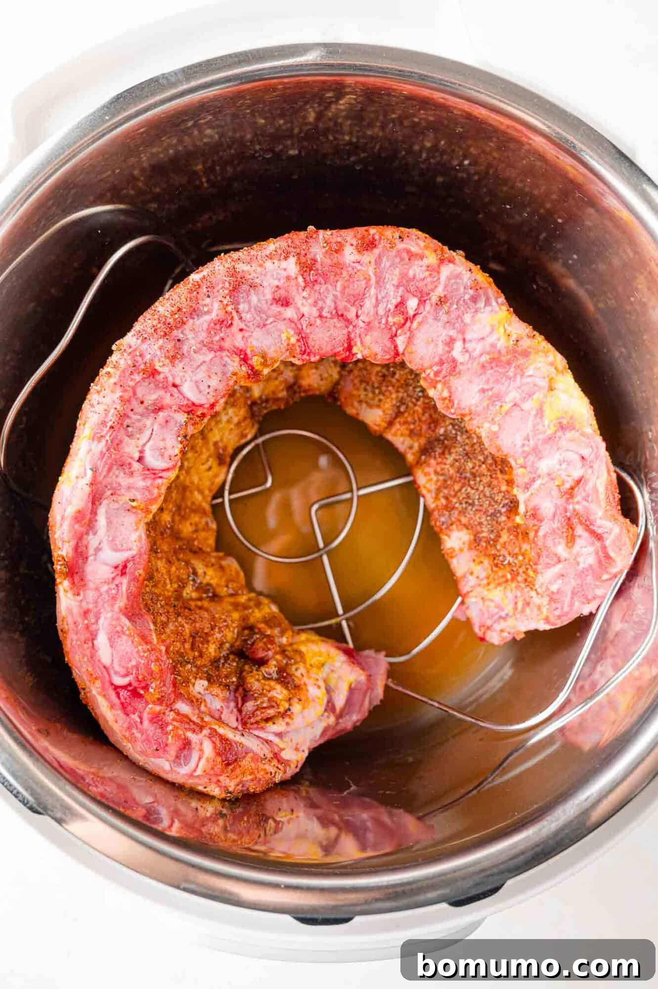 Instant Pot Ribs: Quick & Delicious 9 Uncooked rack of ribs placed in Instant Pot.