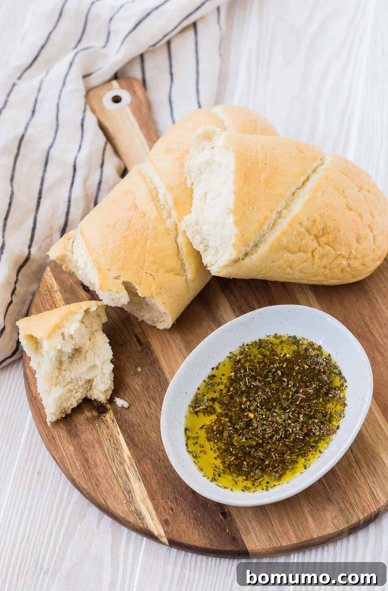 Olive oil and herbs on a cutting board