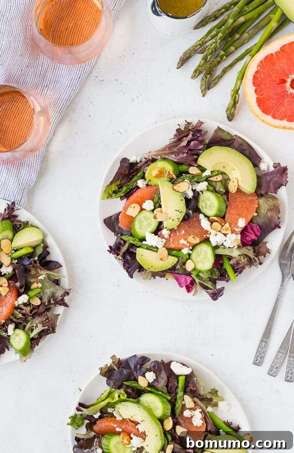 Vibrant Spring Salad with Grapefruit, Asparagus, Avocado, Feta, Almonds, and Rosé Vinaigrette. A visually stunning and healthy dish.
