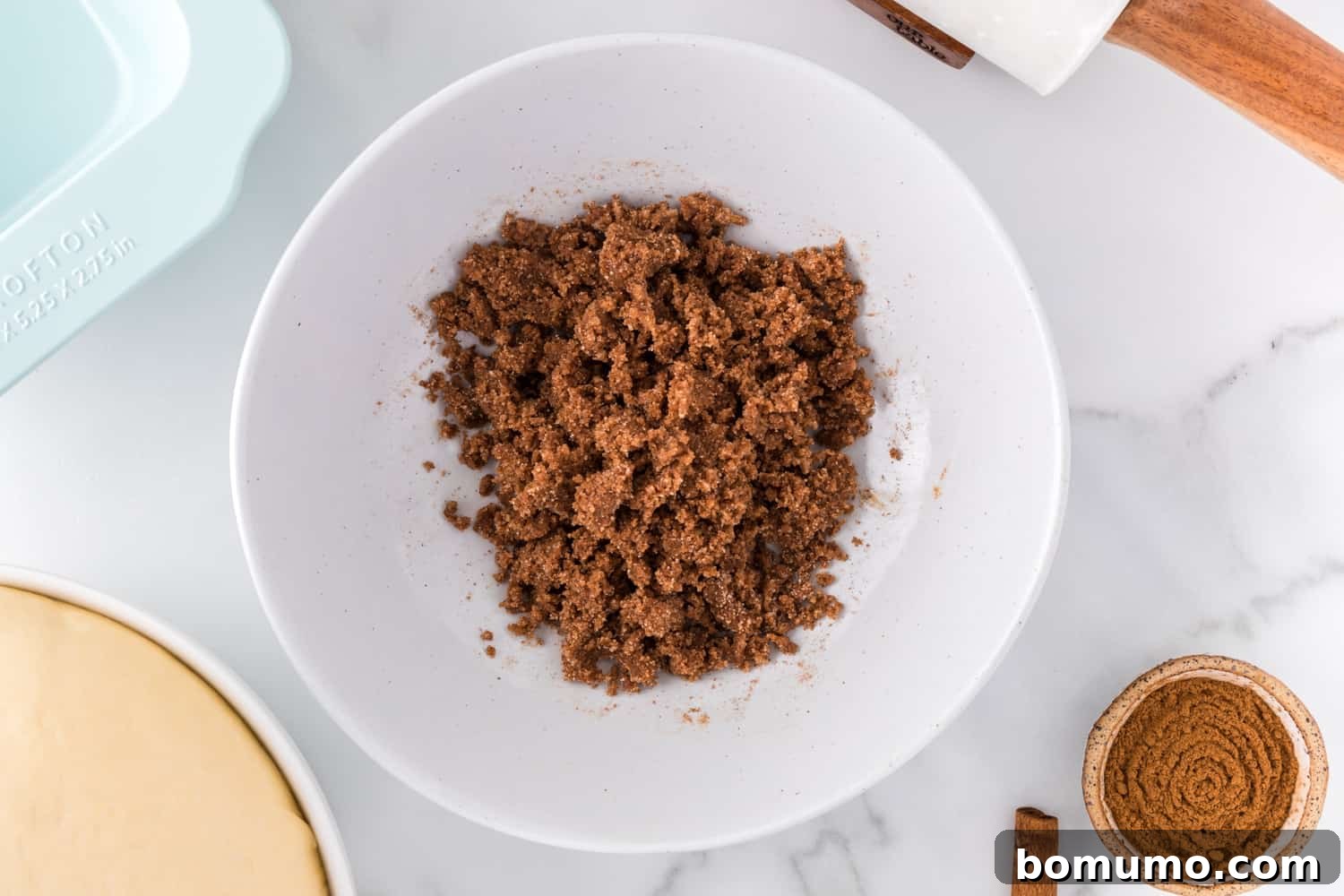Cinnamon swirl mixture perfectly combined in a bowl, resembling wet sand.