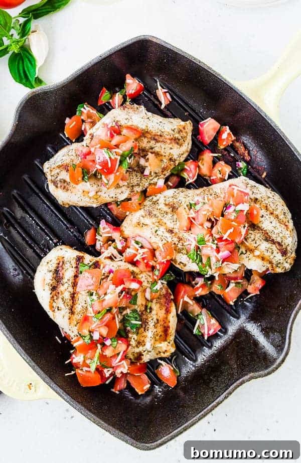 Overhead of three portions of bruschetta chicken in grill pan.