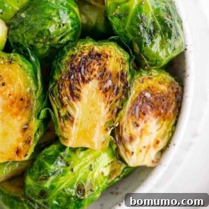 Perfectly sautéed Brussels sprouts in a white bowl.