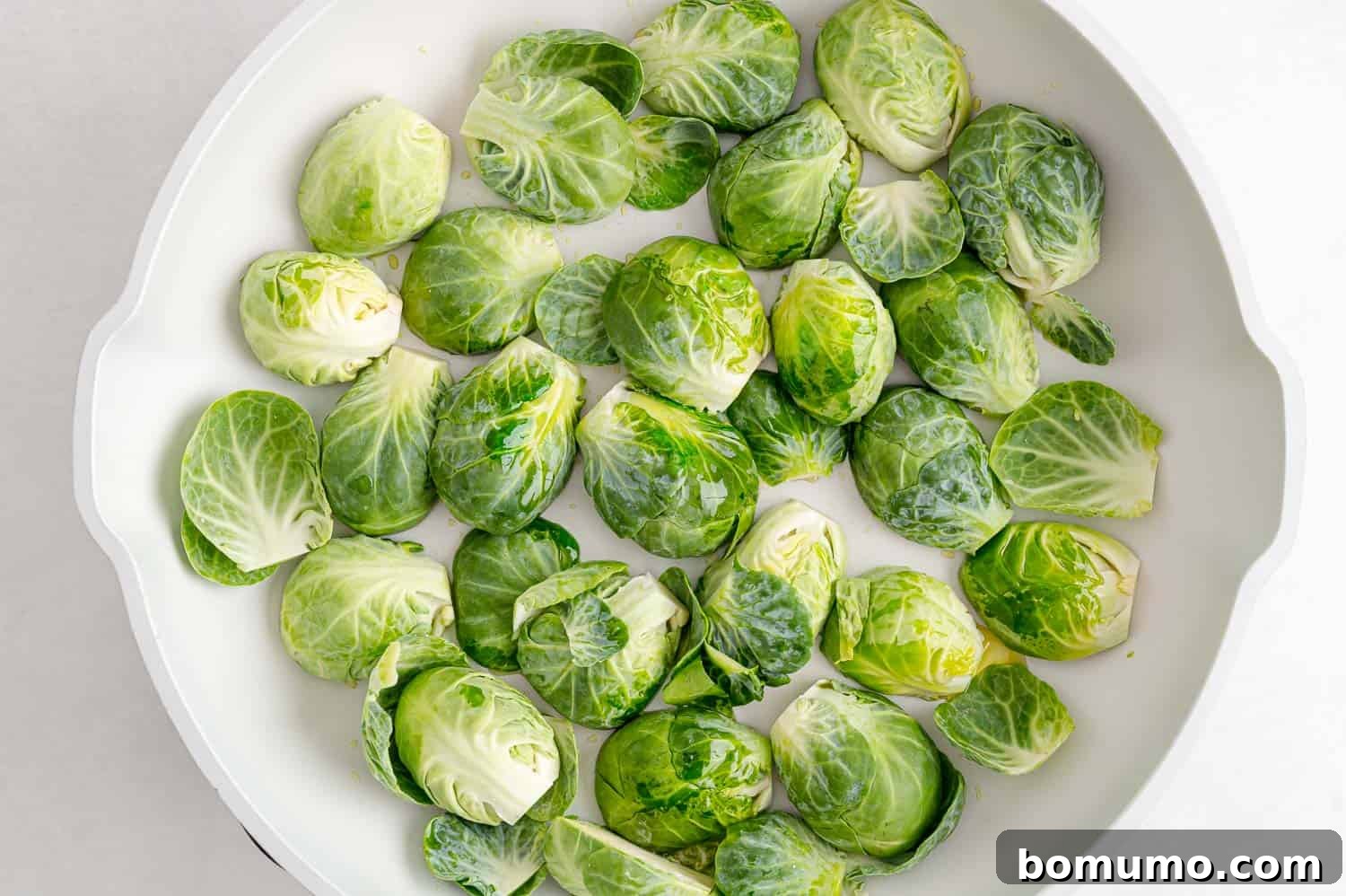 Uncooked Brussels sprouts in a pan.