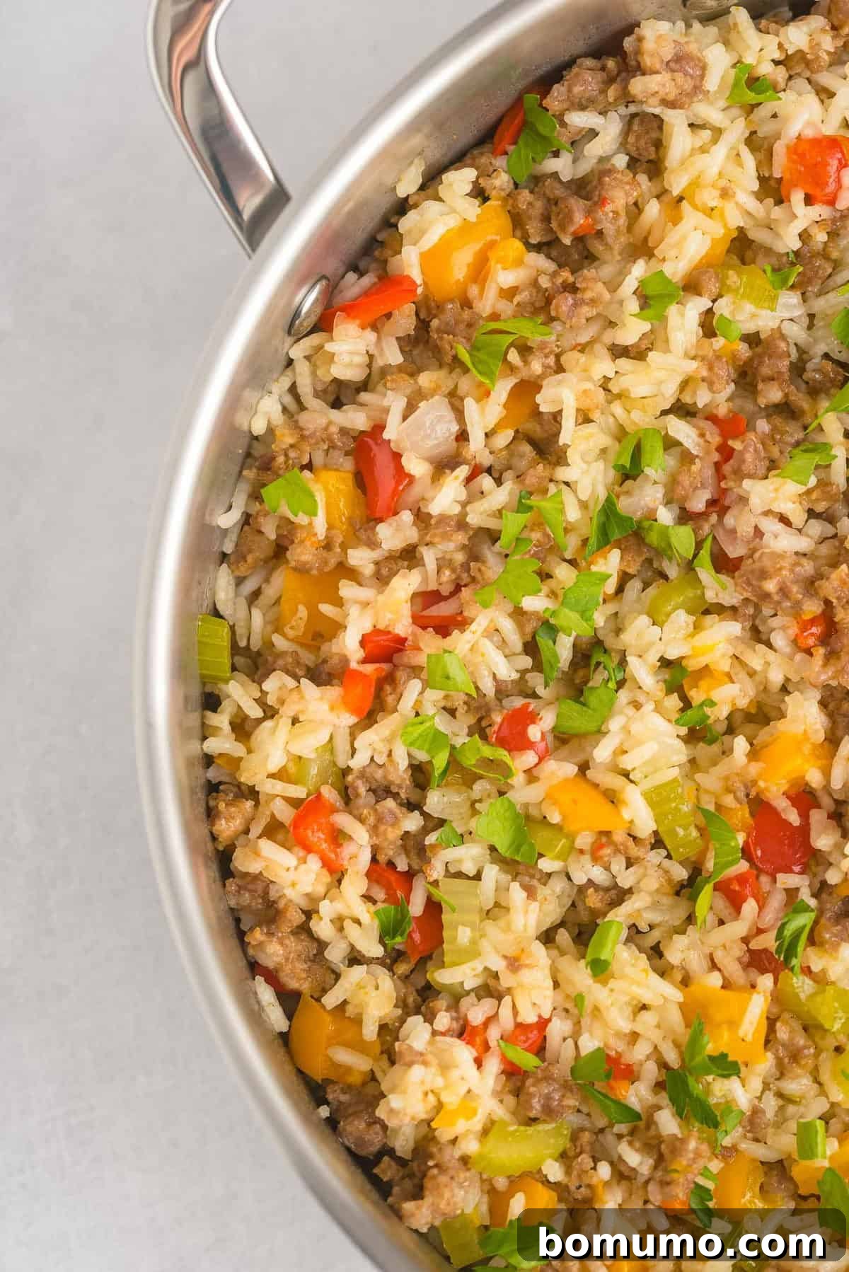 A beautifully composed image showing a complete skillet full of savory rice, flavorful sausage, and colorful peppers, perfectly cooked and ready to be served.