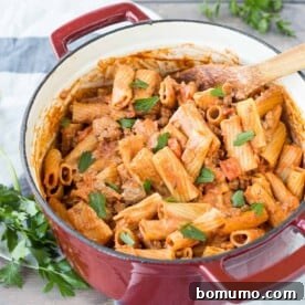 Overhead of rigatoni in red Dutch oven, ready to serve.