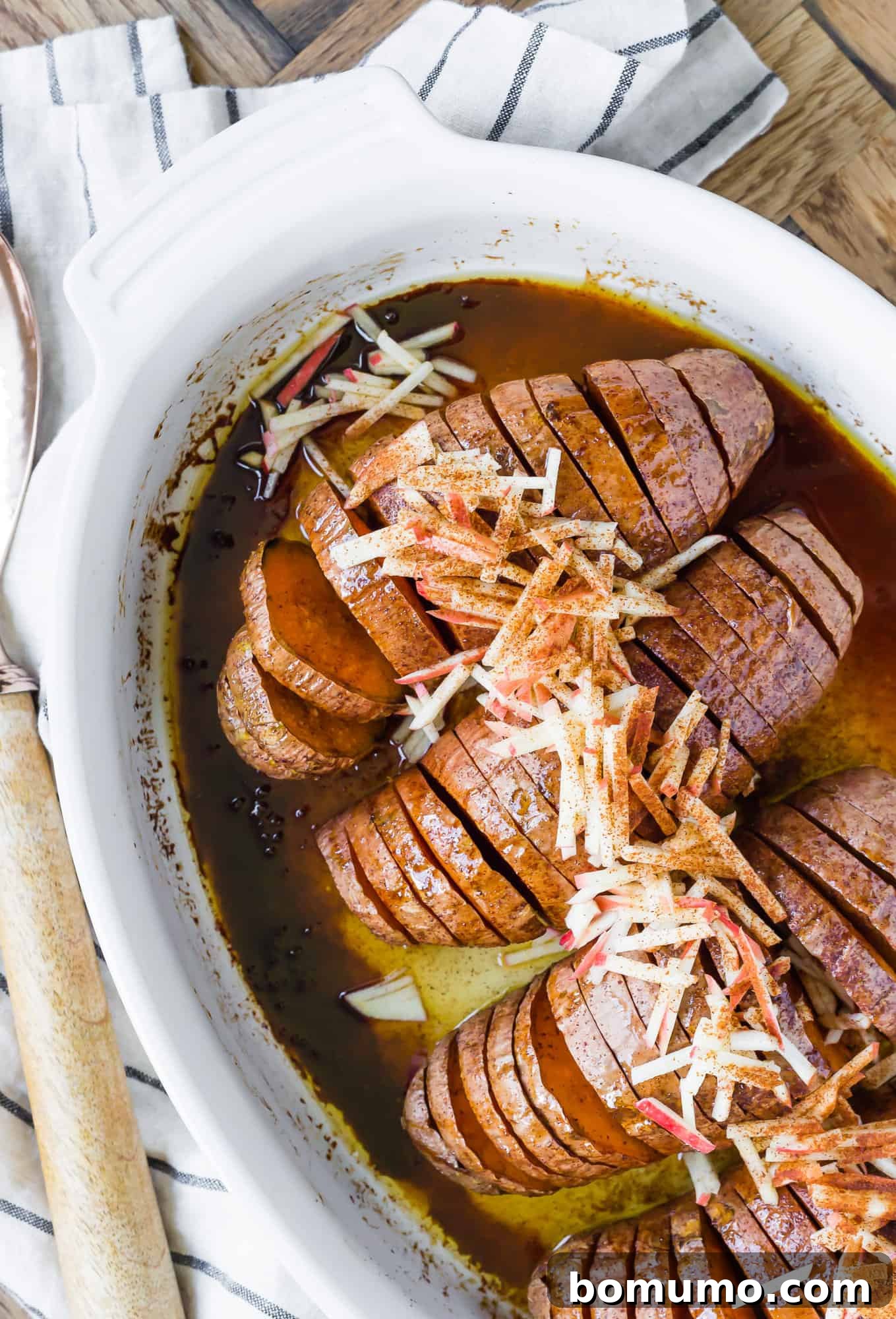 Crispy Hasselback Sweet Potatoes 6 Sweet potatoes, cut in a hasselback style, in a white baking dish.