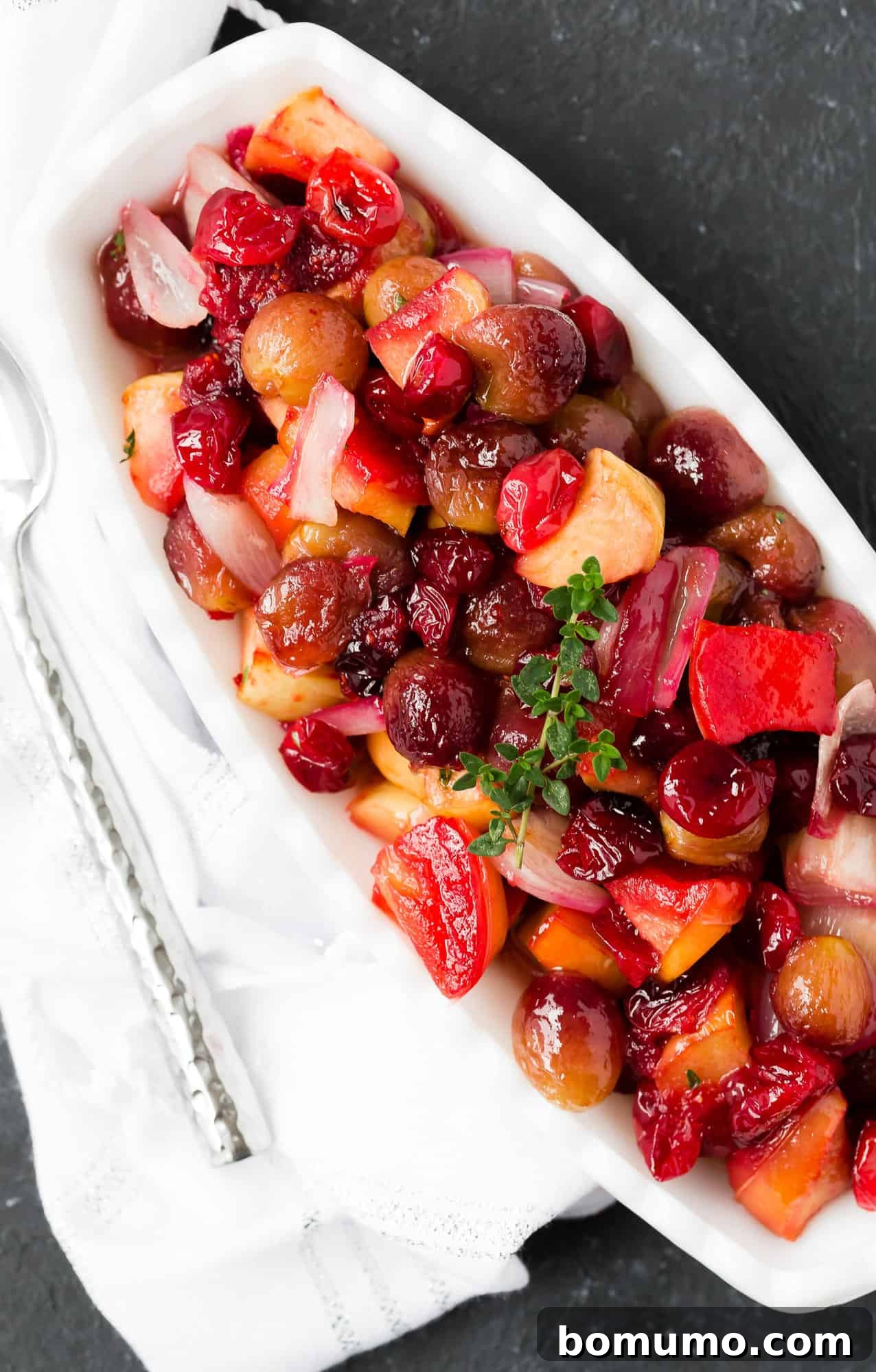 A festive serving of cranberry, grape, and shallot sauce in a decorative bowl, ready for a holiday meal.