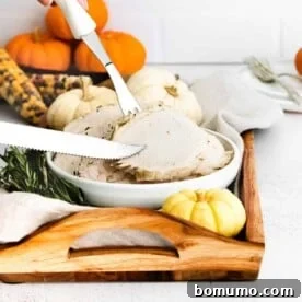 Perfectly sliced Instant Pot turkey breast with a knife and fork, ready to serve.
