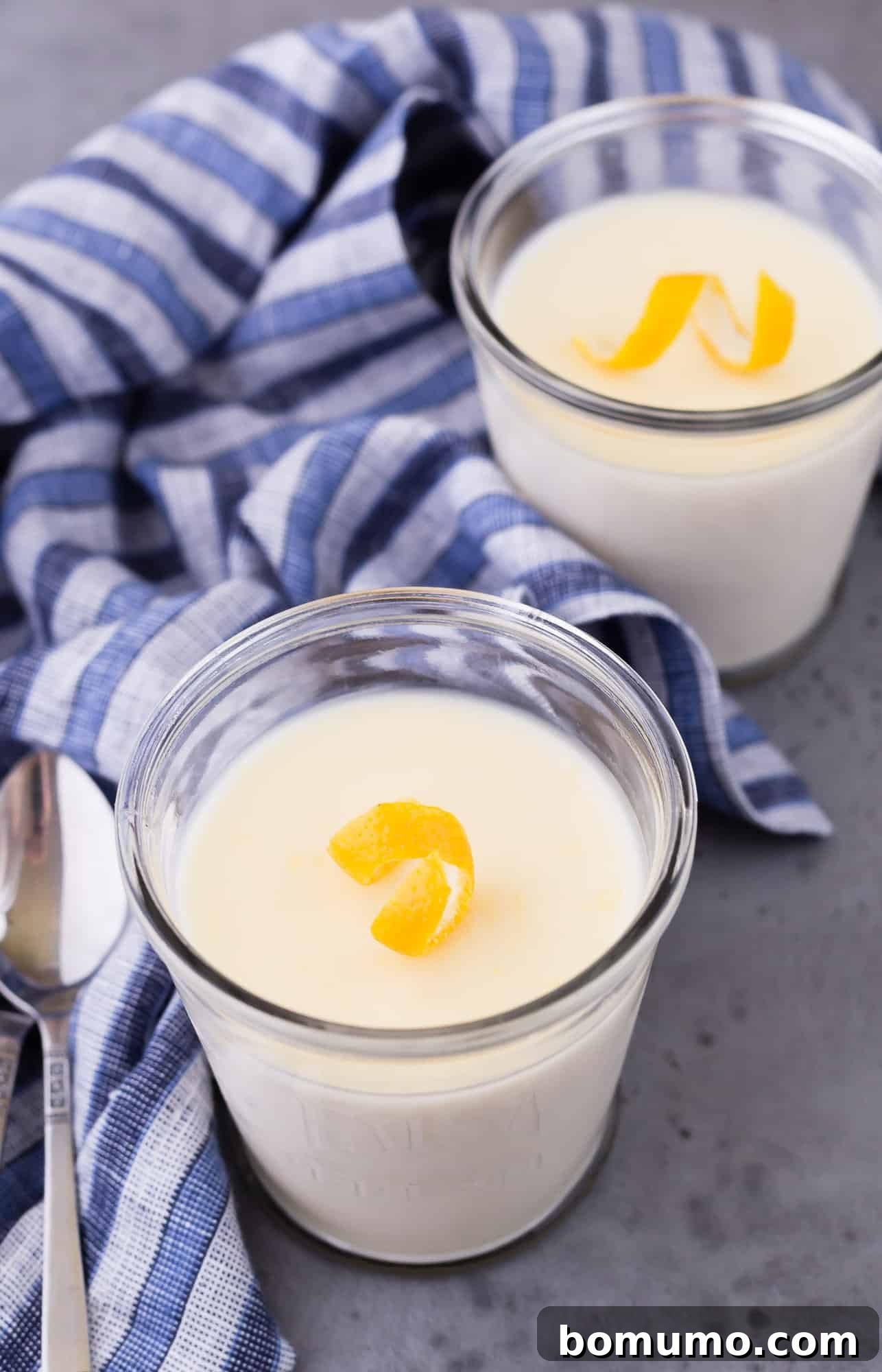 Easy 3-Ingredient Lemon Pudding 4 Close-up of a small, individual serving of lemon pudding, garnished with fresh lemon zest and a delicate lemon twist.