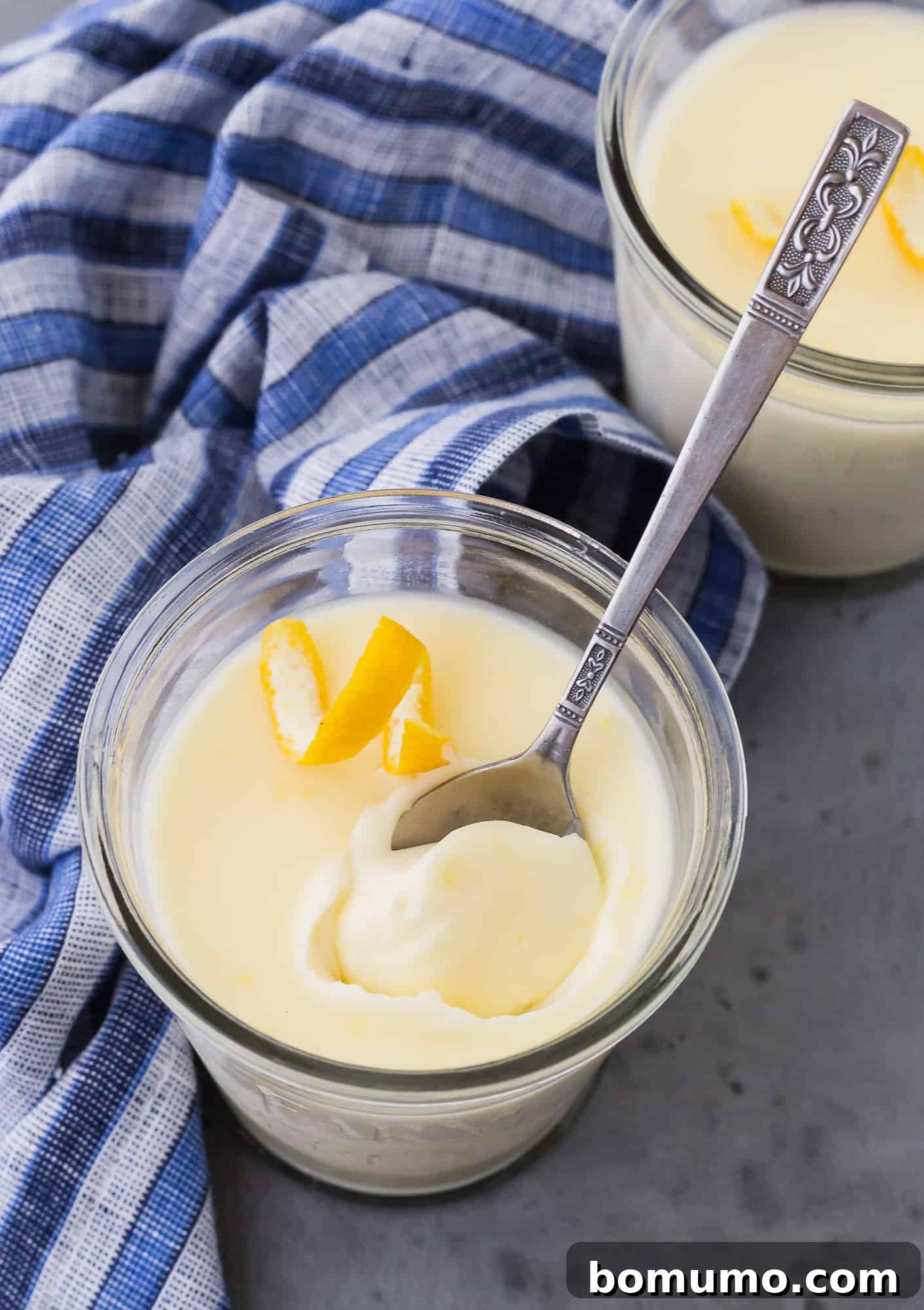 Easy 3-Ingredient Lemon Pudding 5 A tantalizing serving of lemon-flavored pudding, captured with a spoon gracefully inserted, highlighting its smooth, creamy texture.