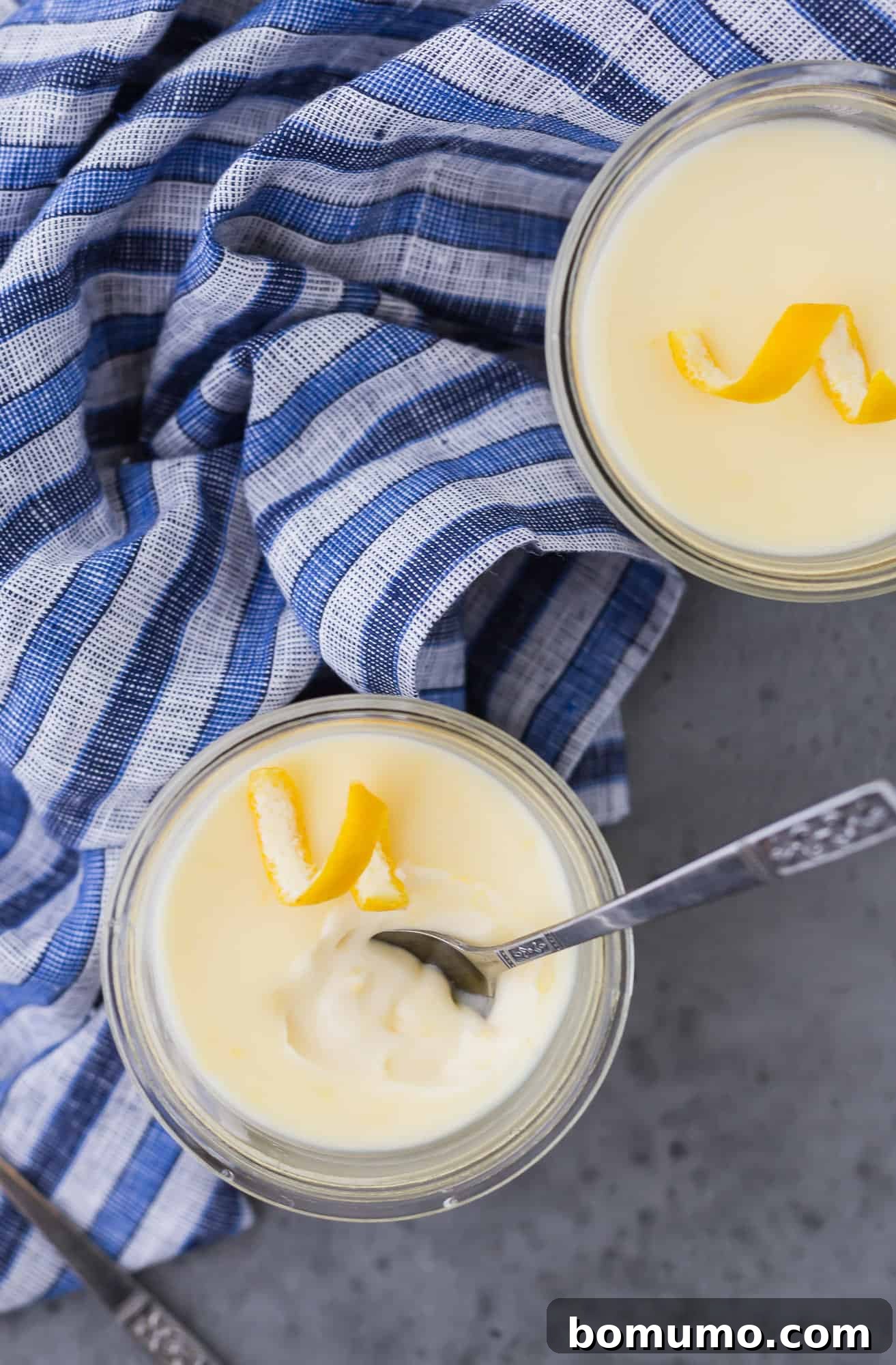 Easy 3-Ingredient Lemon Pudding 6 A scoop of luscious lemon pudding in a small bowl, ready to be enjoyed, with a spoon resting in its creamy depths.