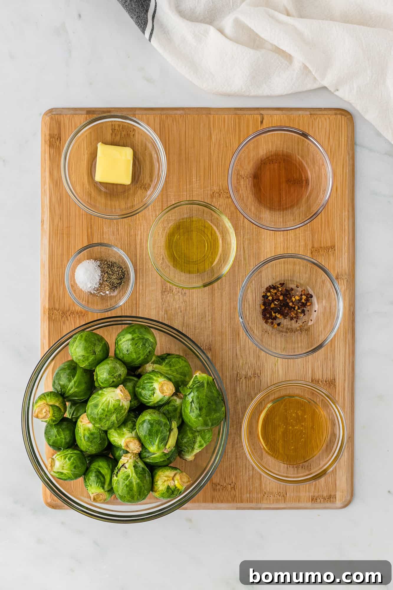 An overhead view showcasing all the fresh and vibrant ingredients perfectly arranged, ready for the Air Fryer Brussels Sprouts recipe, including the optional hot honey glaze components.