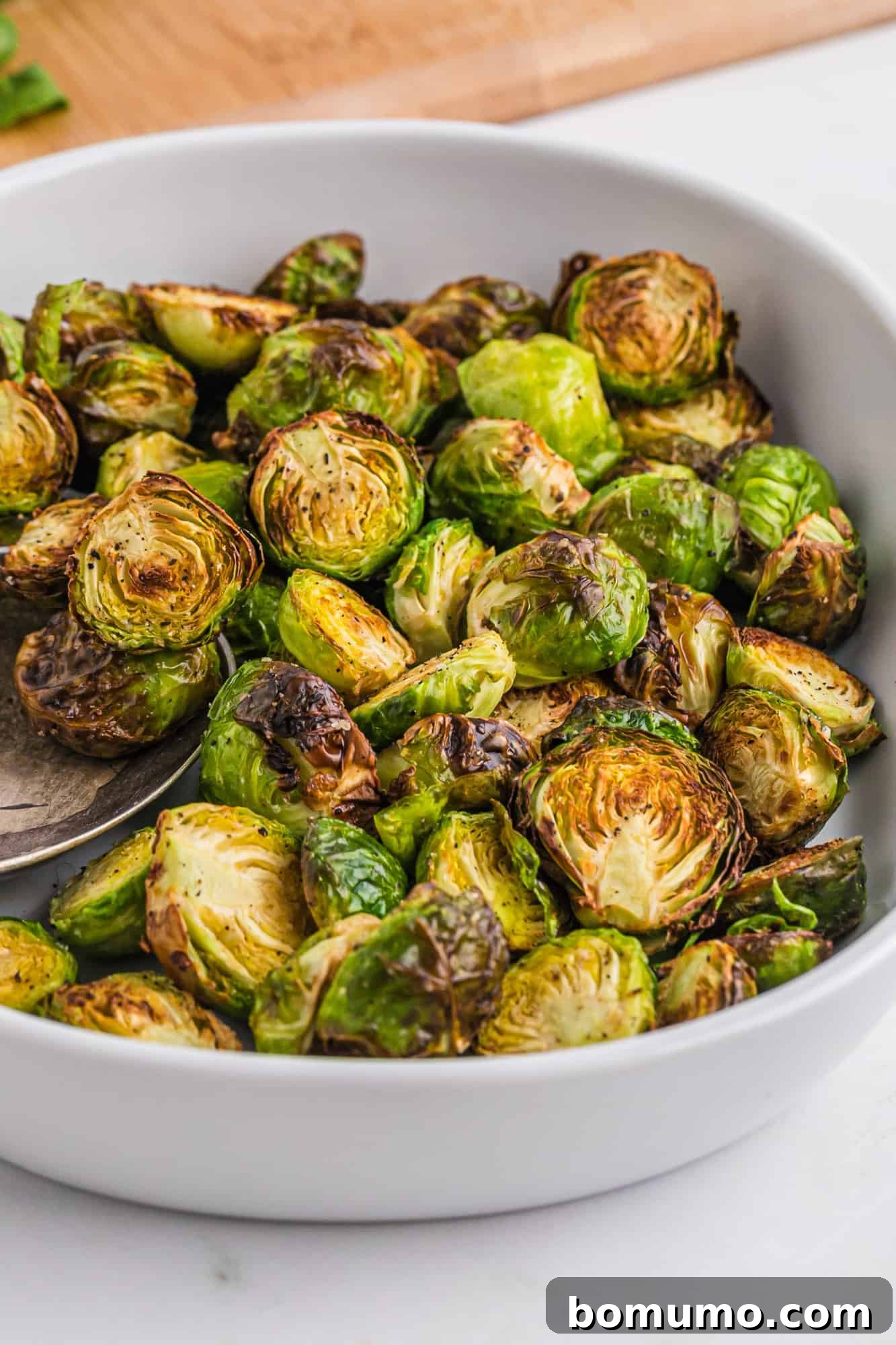 A vibrant casserole dish filled with beautifully cooked Brussels sprouts, tossed in a flavorful glaze, ready to be served.