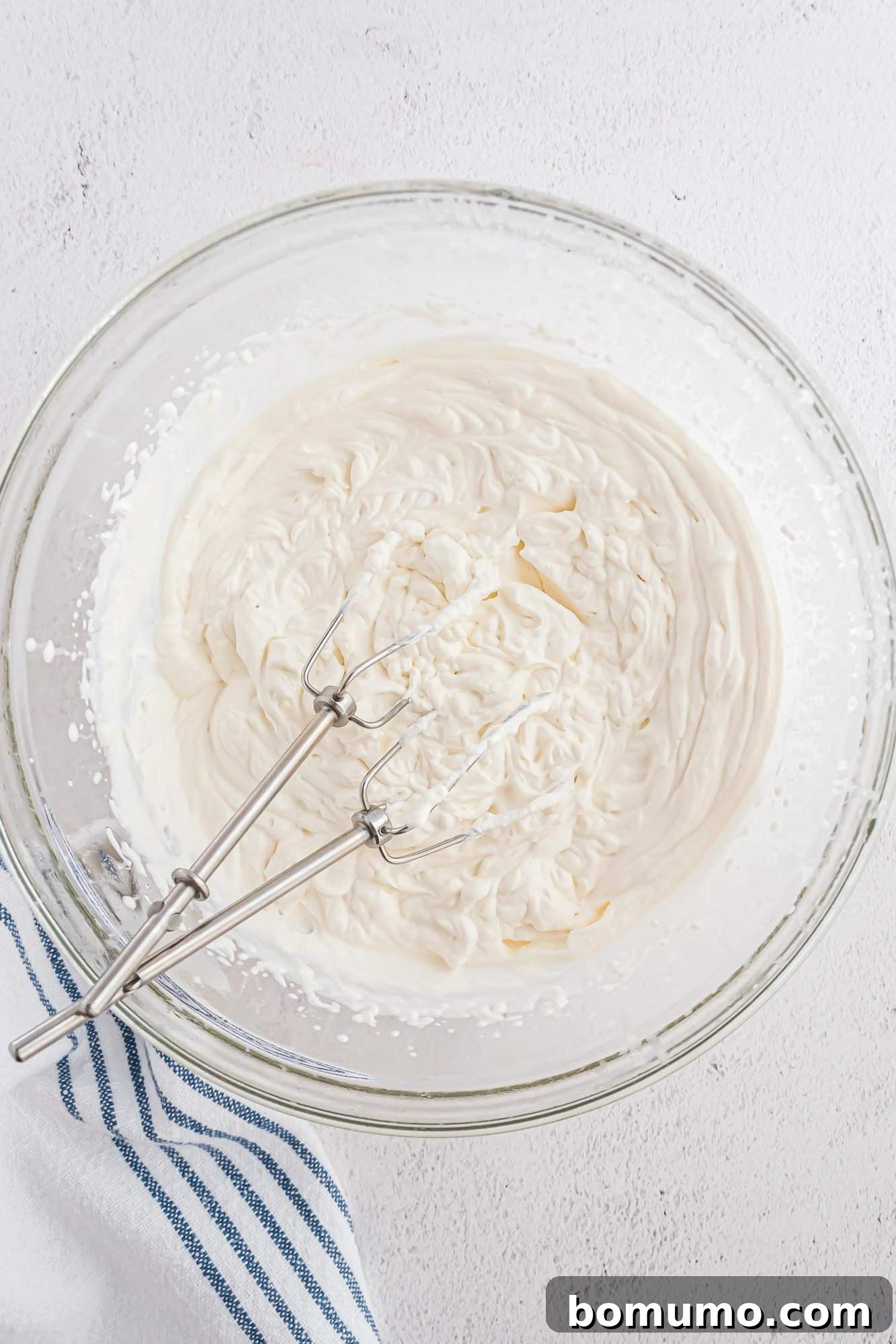 Whipped cream after beating, showing perfect soft peaks.