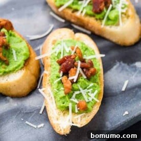 Image of creamy pea puree spread on crispy bread slices, topped with pancetta and Parmesan cheese.
