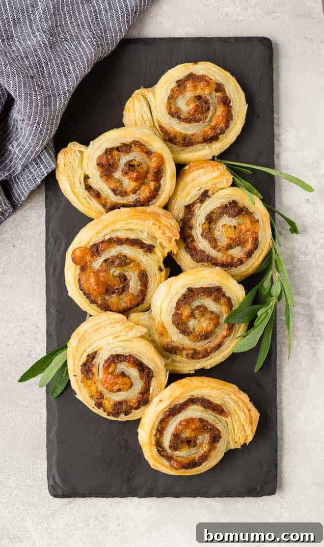 Sausage puff pastry wheels made with apple and gruyere, overhead view.