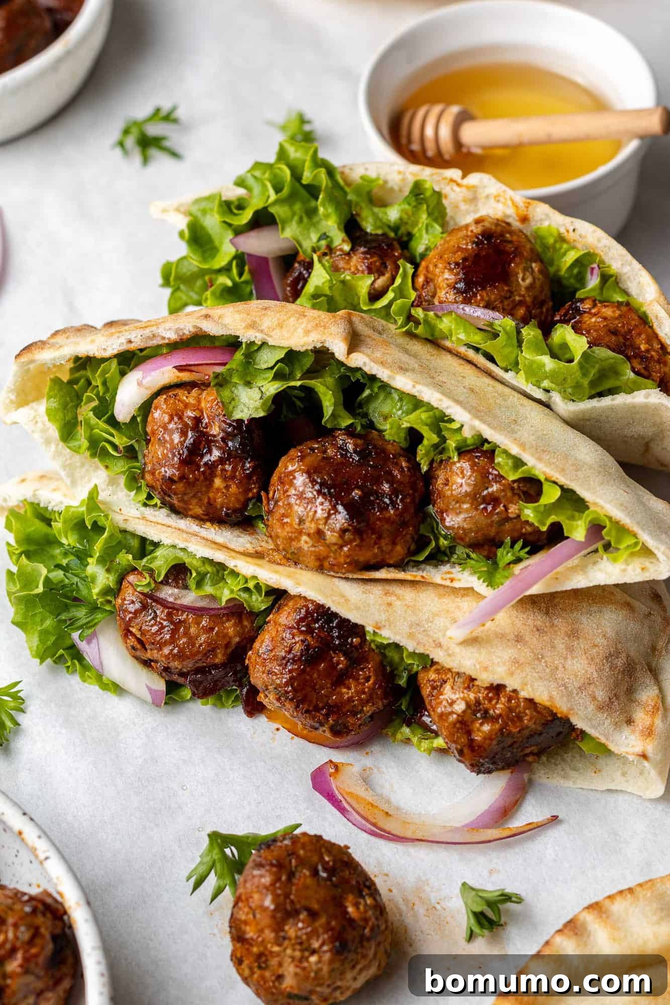 Meatball pitas with onion and lettuce.