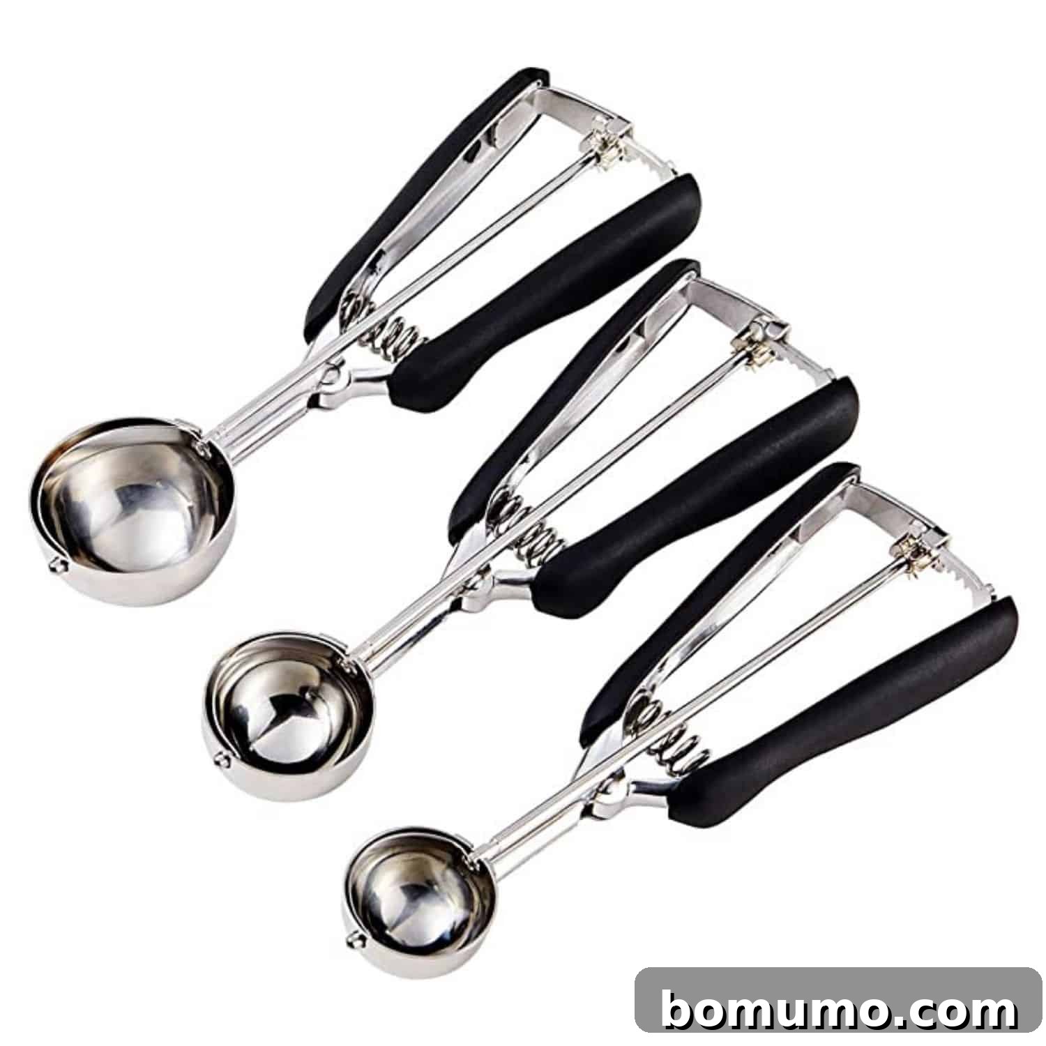 Three cookie scoops on a white background.