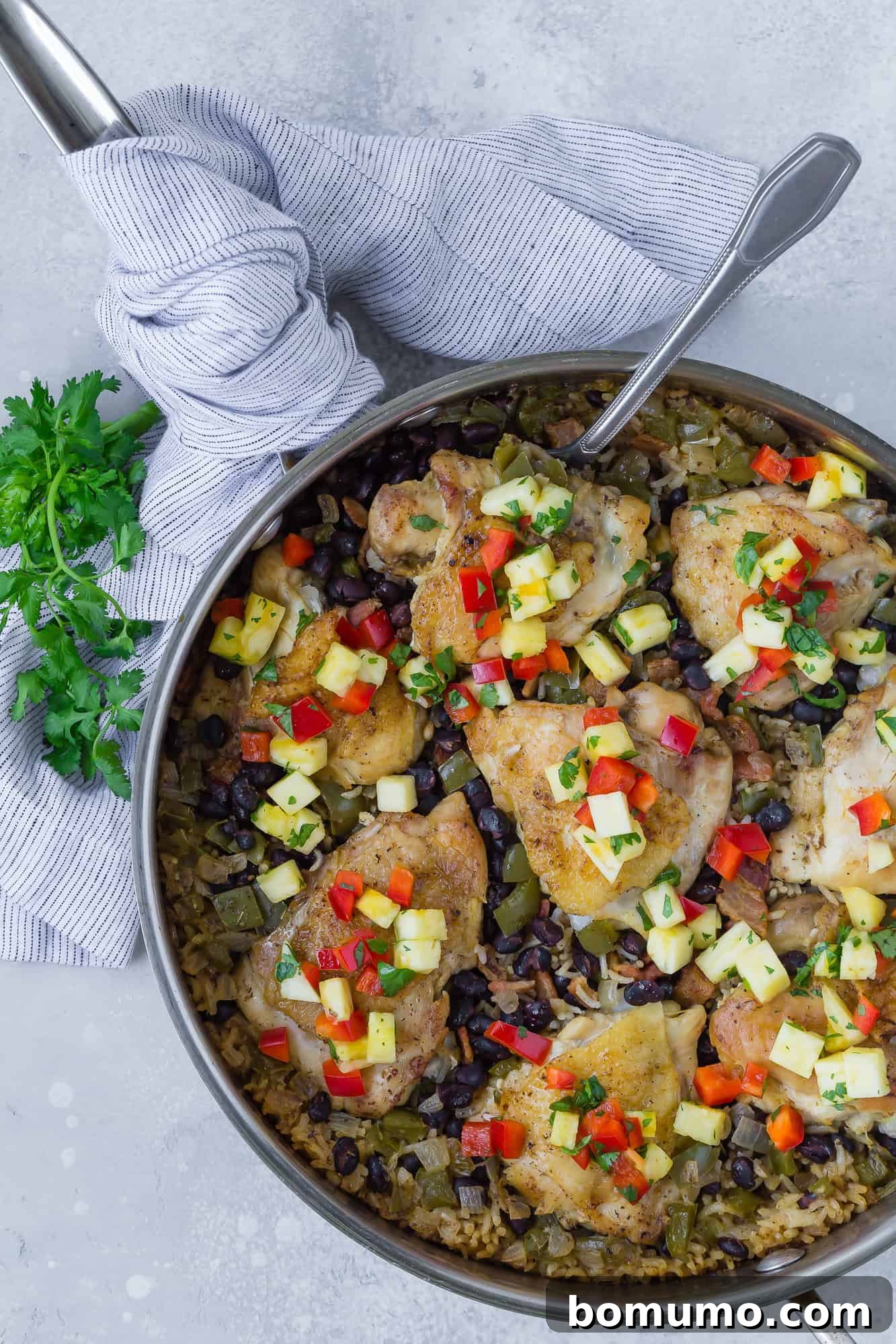Overhead view of cuban chicken and rice, still in pan.