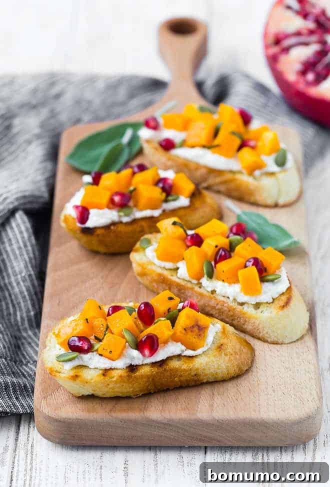 Crostini with squash, pomegranate, ricotta, and pepitas.
