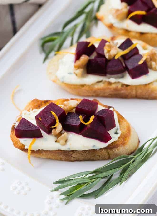 Vibrant beet crostini, delicately garnished with fresh tarragon leaves, showcasing the beautiful contrast of colors.