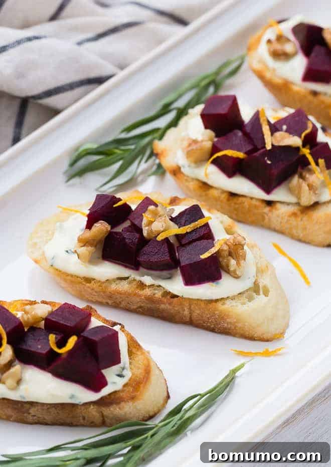 A close-up view of vibrant beet crostini elegantly arranged on a pristine white platter, highlighting the rich colors and textures of the appetizer.