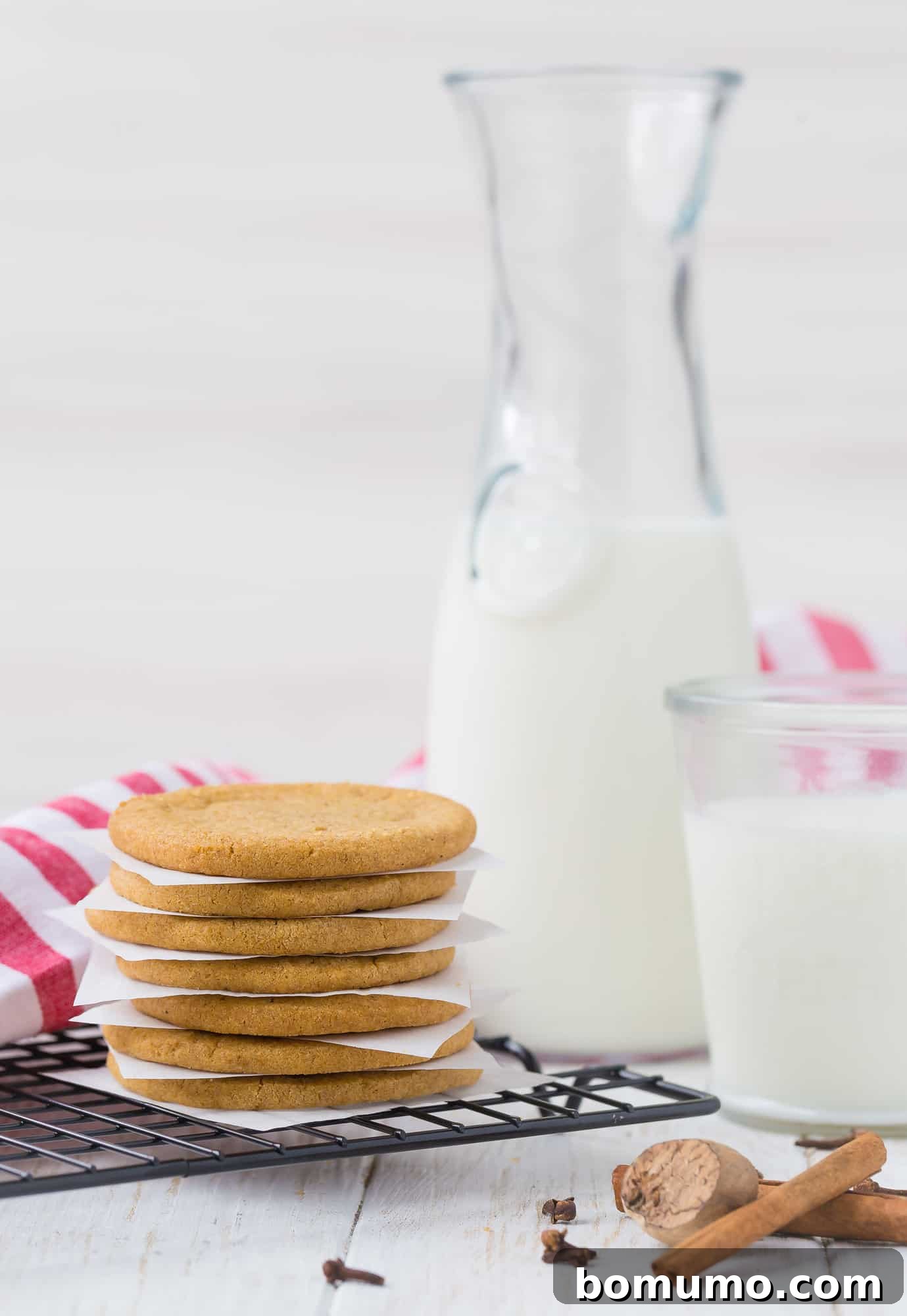 Stack of freshly baked Windmill Cookies with a glass of milk in the background, highlighting their rustic charm and golden-brown perfection.